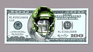 A $100 bill with a football helmet on Ben Franklin.