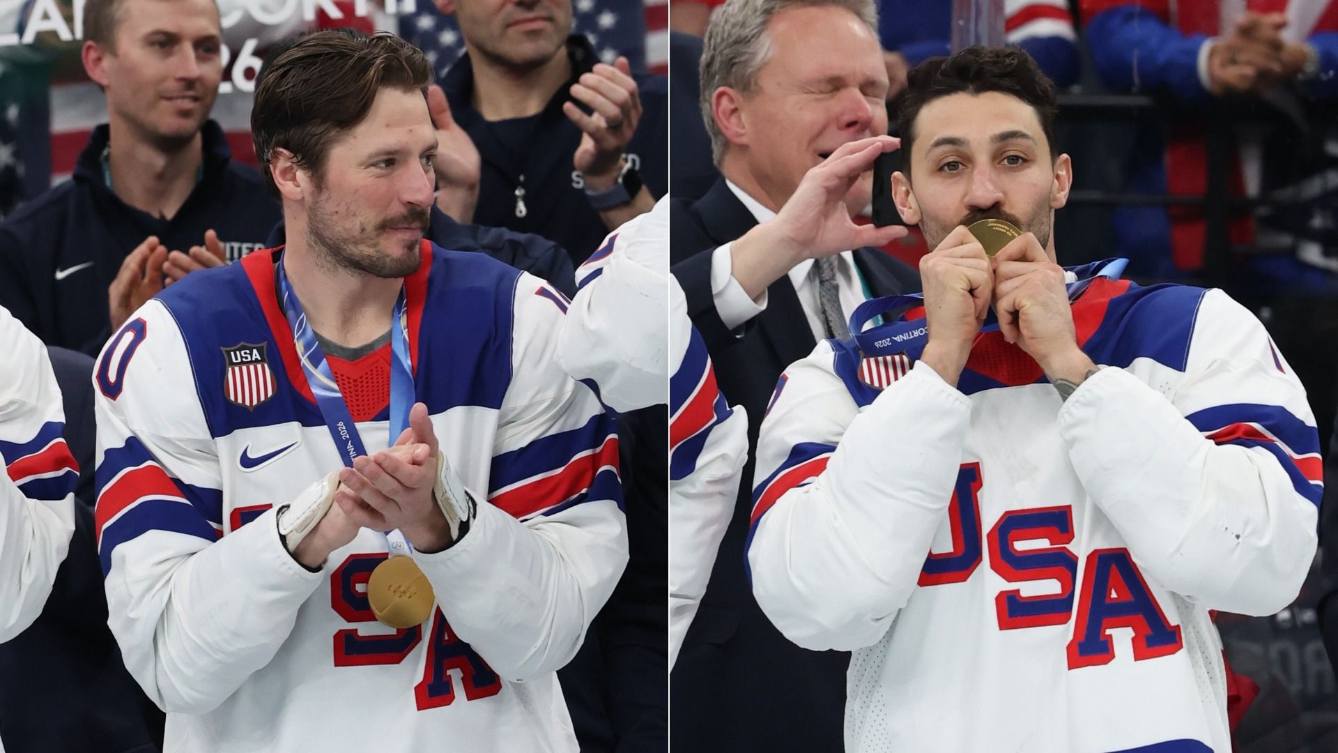 Two USA hockey players in white jerseys with red and blue accents celebrating with gold medals at a 2026 event, one kissing his medal, people clapping in the background.