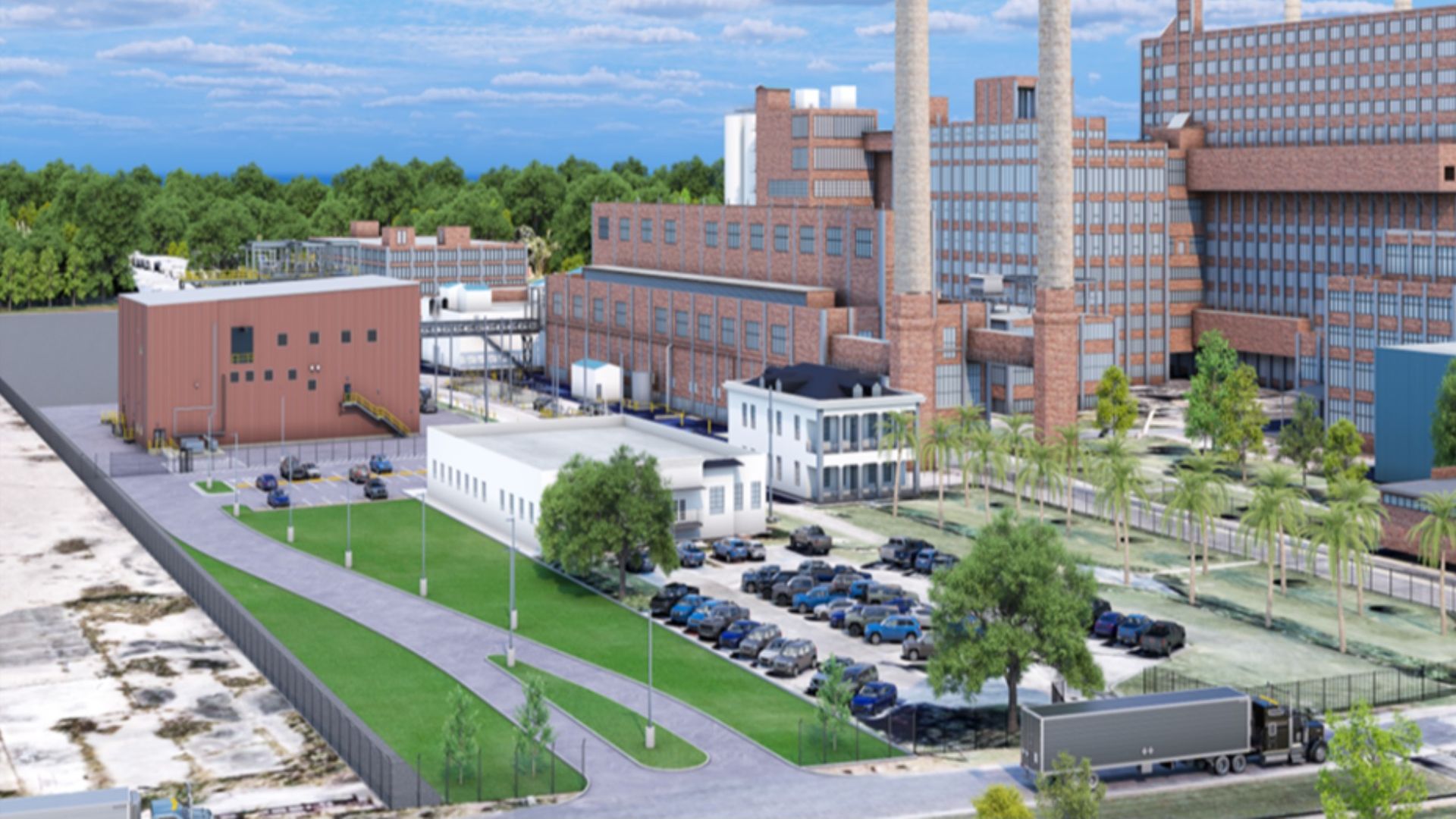 A large brick factory complex with tall smokestacks, connected office buildings, loading docks, and a parking lot of cars; green trees and a blue sky backdrop.