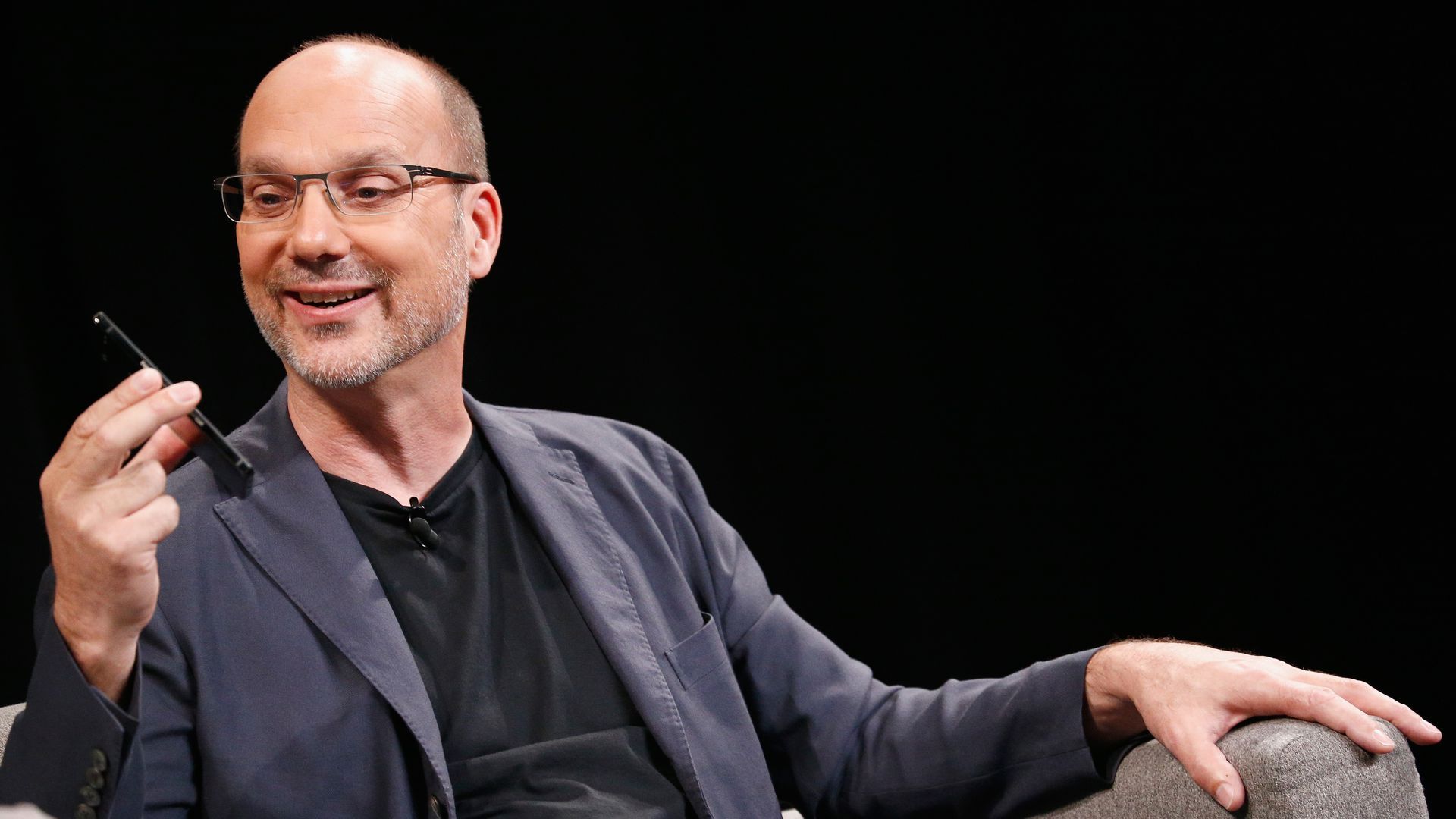 Andy Rubin holding a smartphone