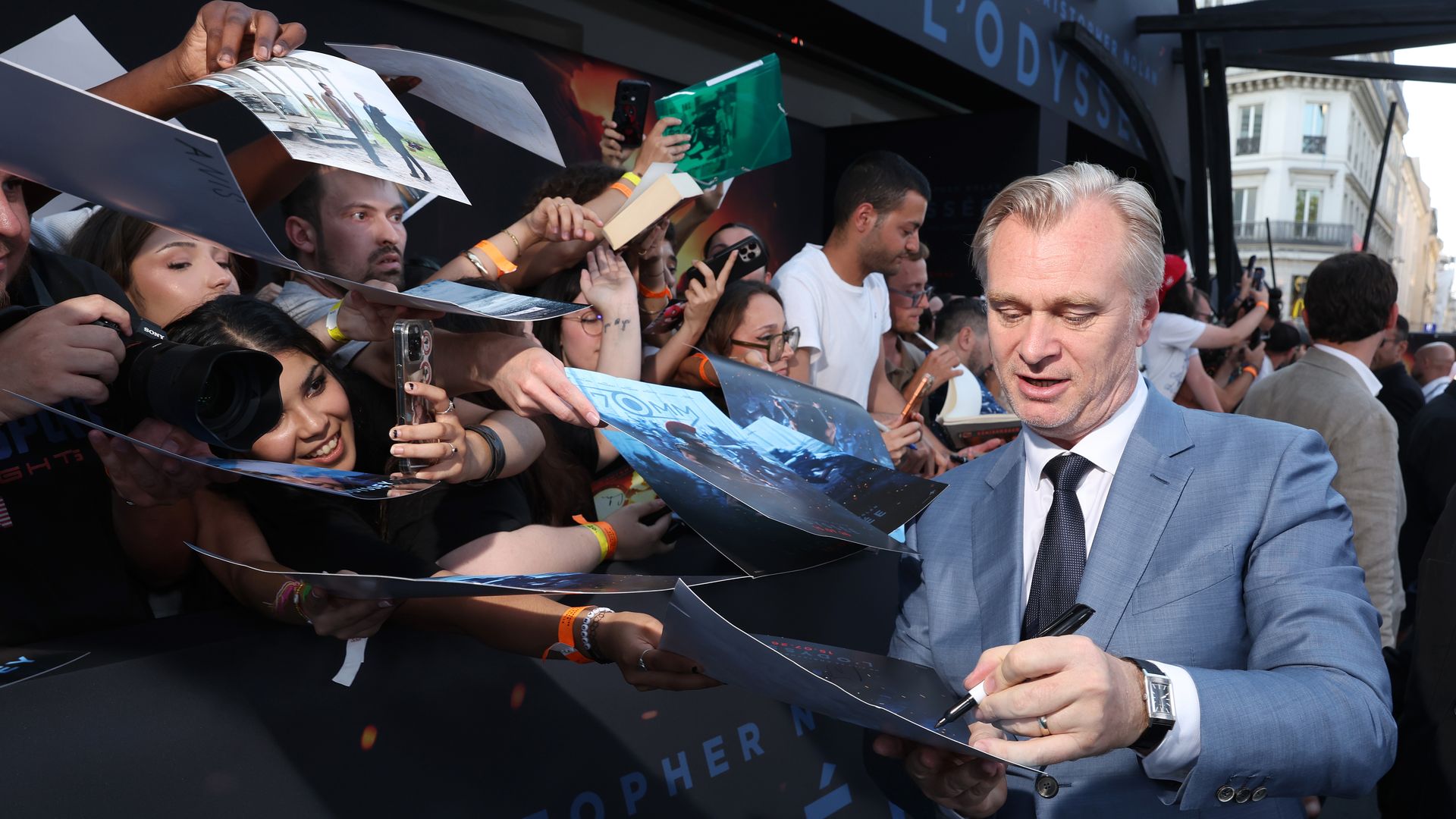 Christopher Nolan interacts with fans during the Paris premiere of "The Odyssey" on July 8.