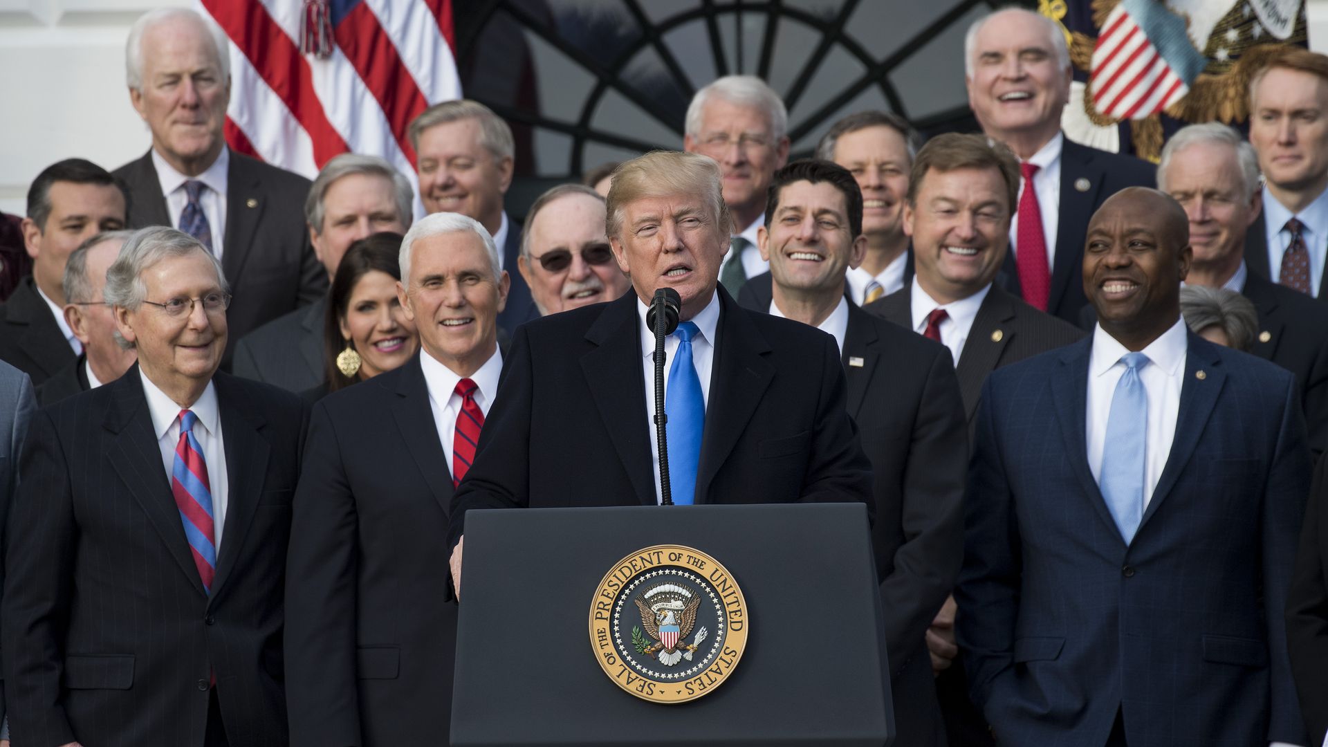 President Trump at lectern flanked by Republican leaders 