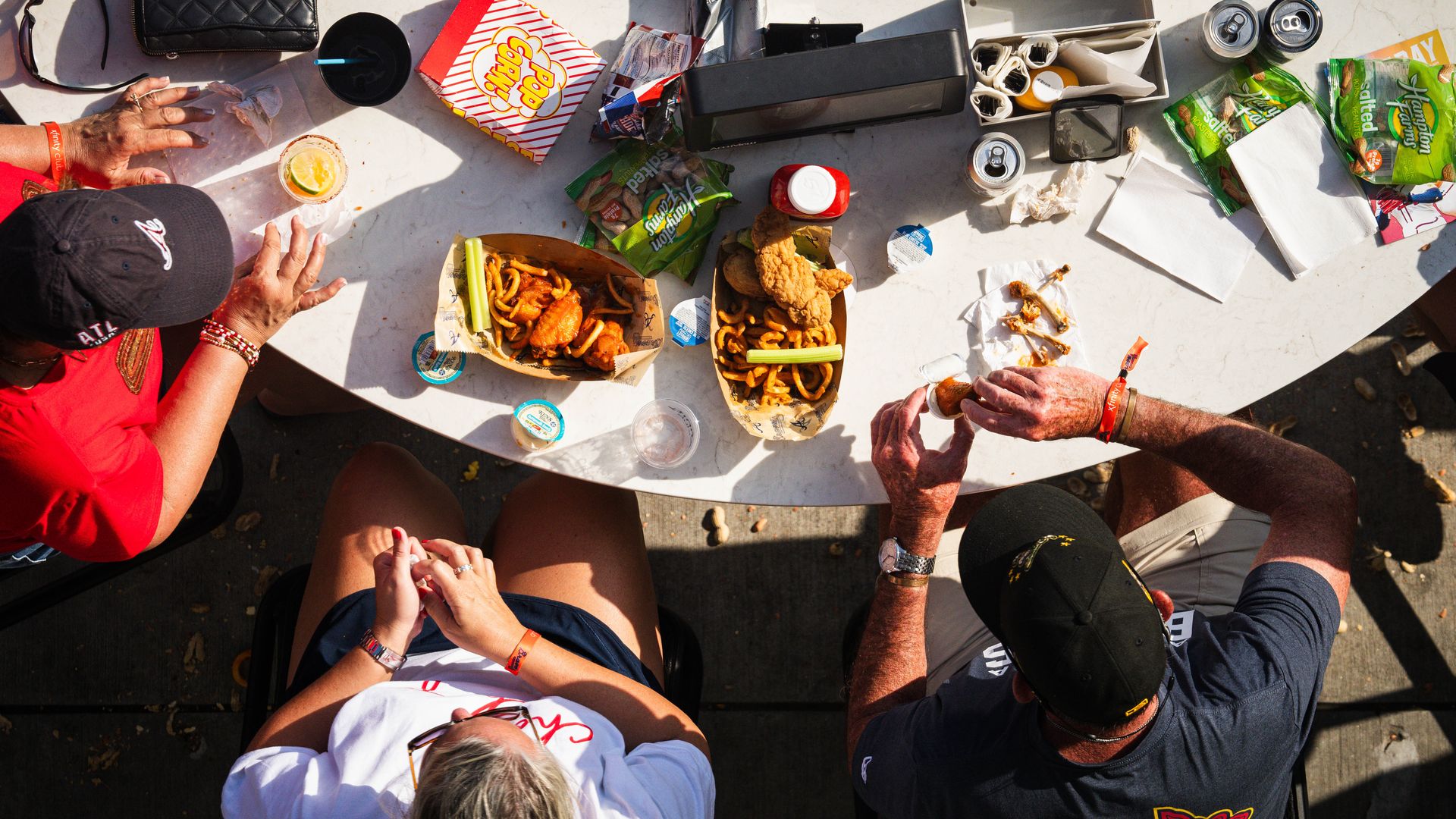An overhead shot of Atlanta Braves fans eating food around a table at Truist Park.