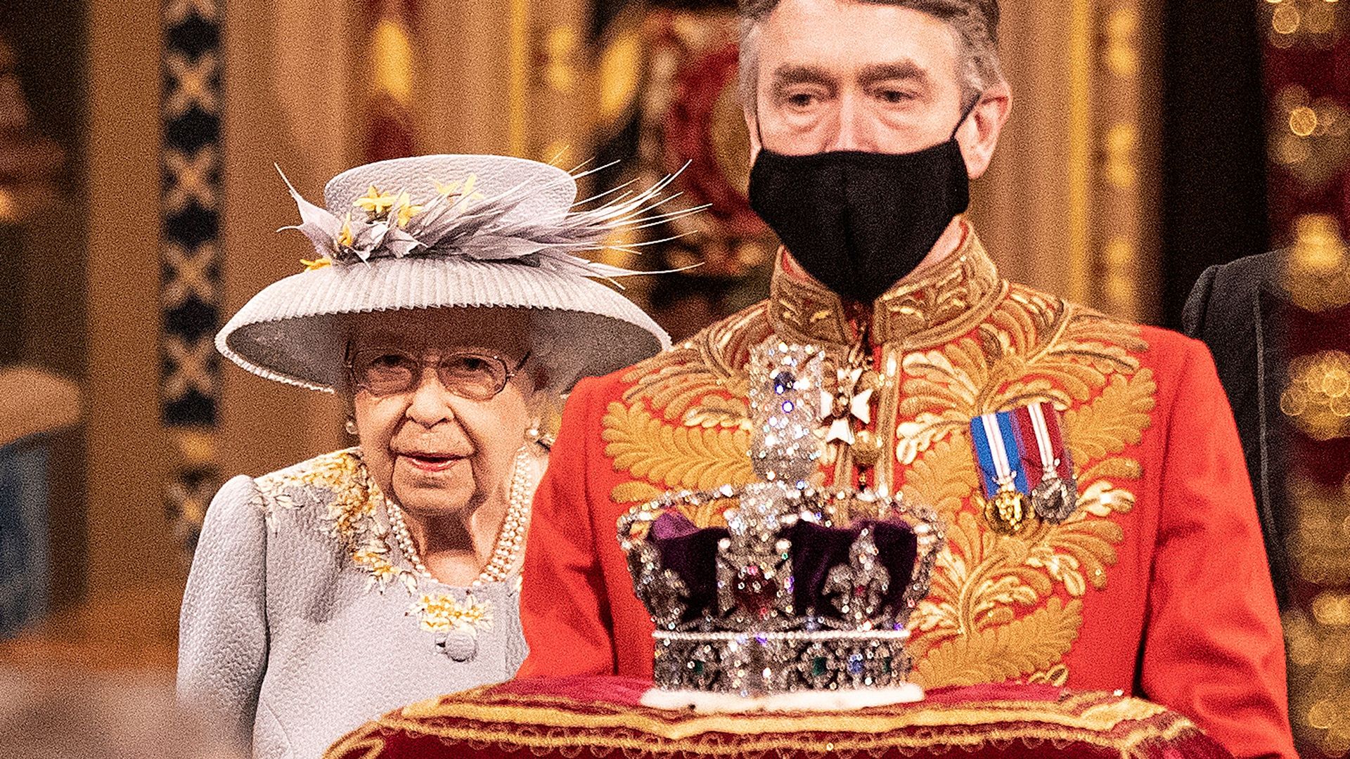 Queen Elizabeth walking behind the crown