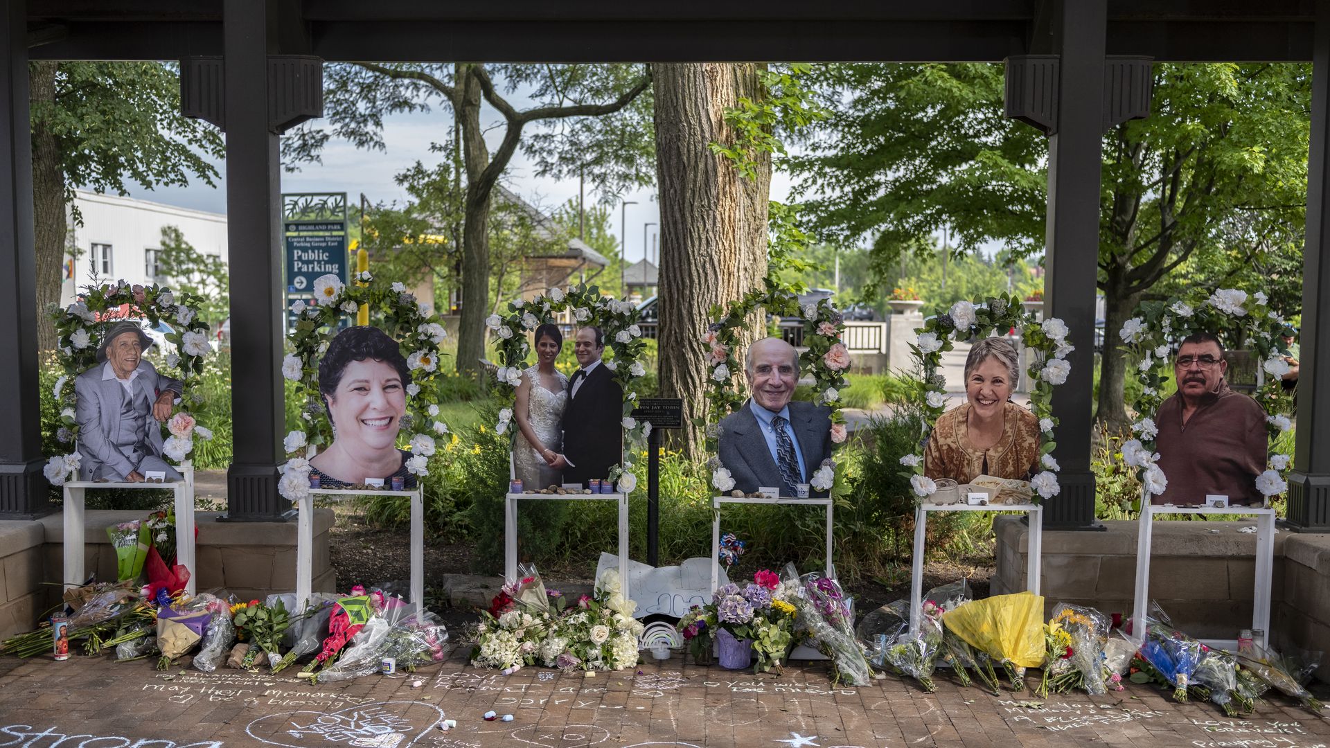 Memorials are placed near the scene of a shooting at a Fourth of July parade, 