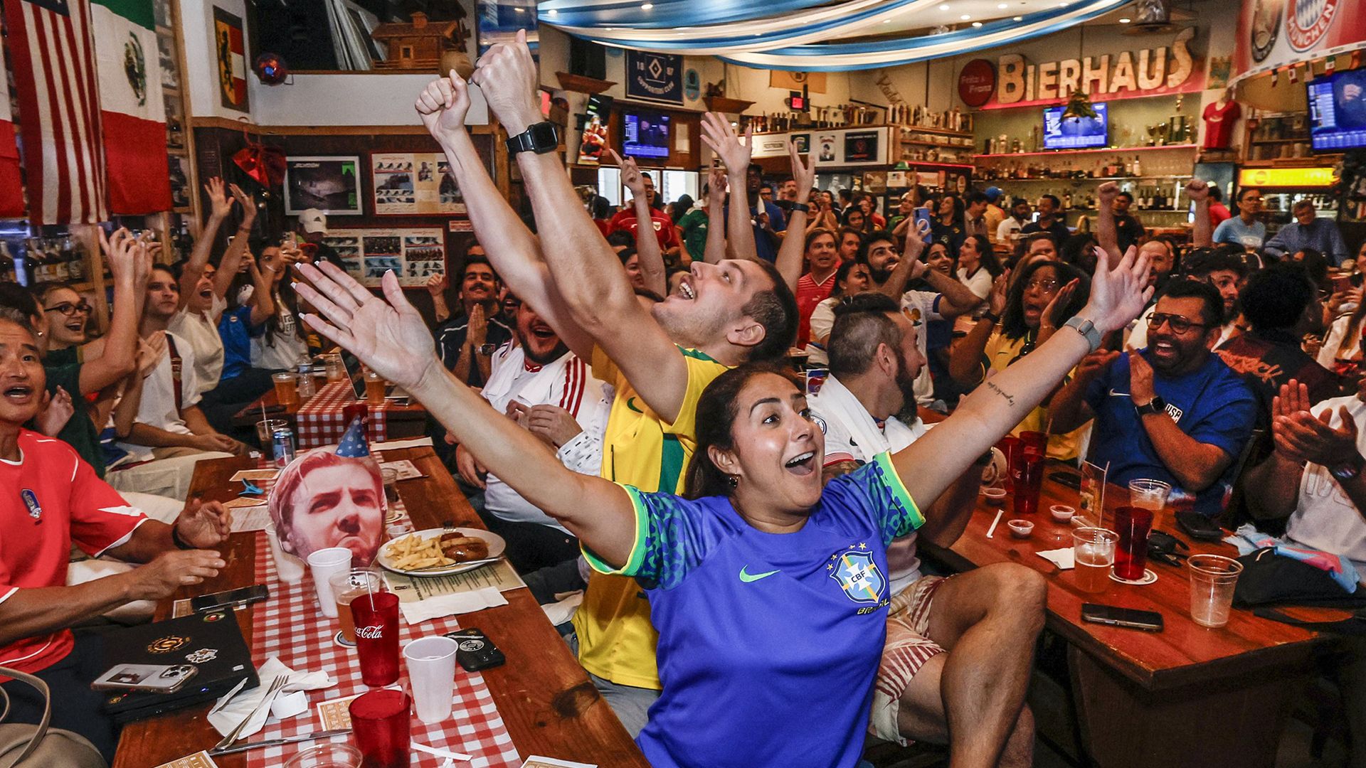 A group of people celebrate in a beer house.