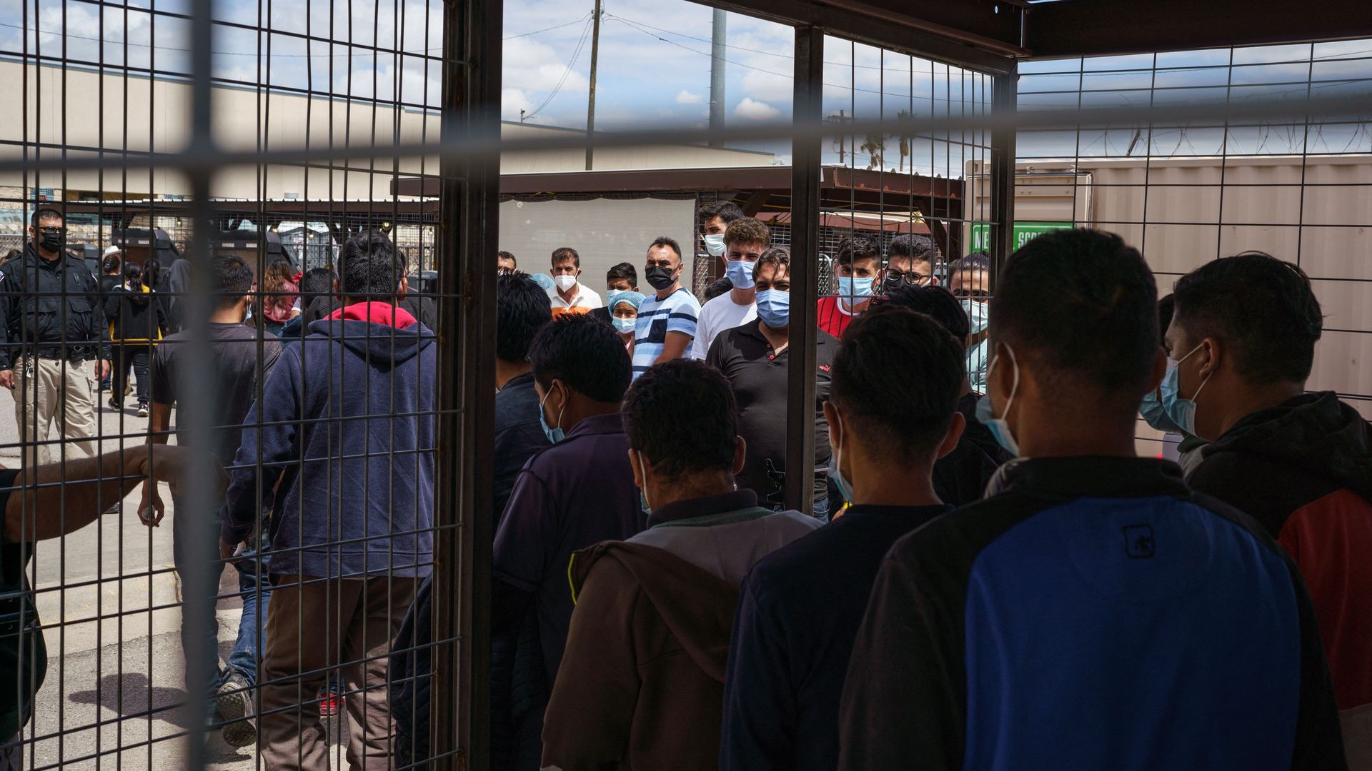 Photo of a crowd of migrants in a detention facility awaiting processing