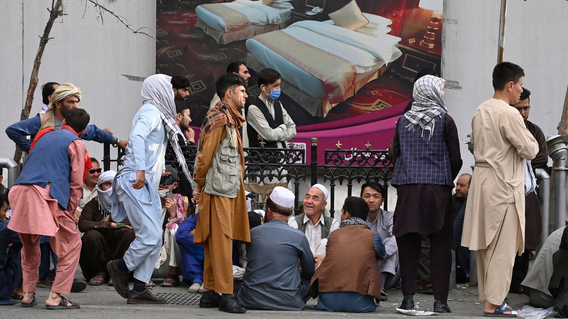 Afghans queue up as they wait for the banks to open in Kabul on Aug. 31, 2021. 