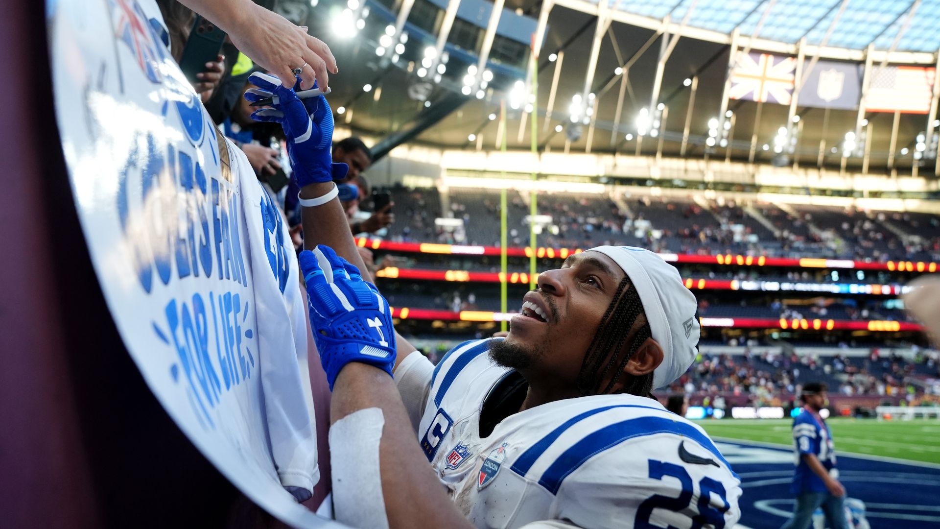 Indianapolis Colts' Jonathan Taylor signs autographs for fans after the NFL International match at the Tottenham Hotspur Stadium, London.