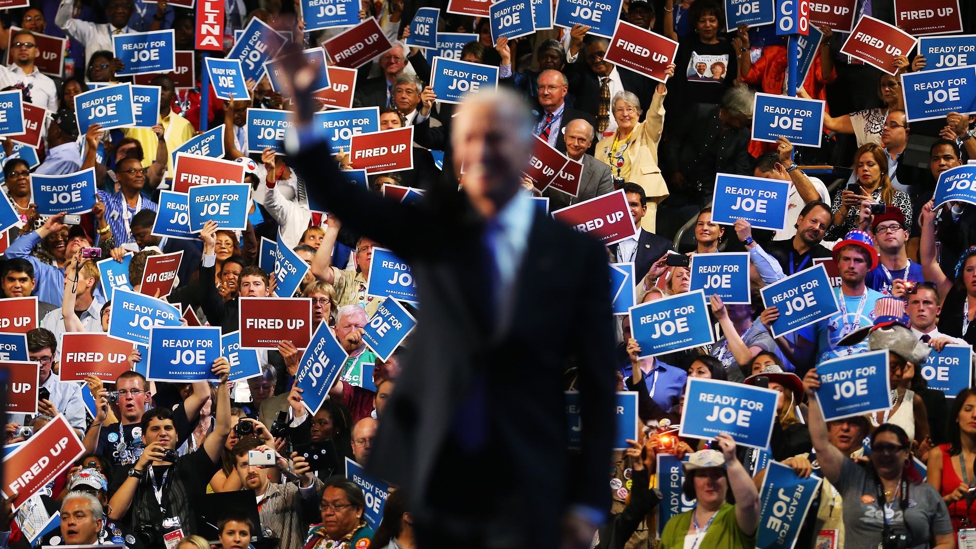 Joe Biden in front of a crowd at a rally.