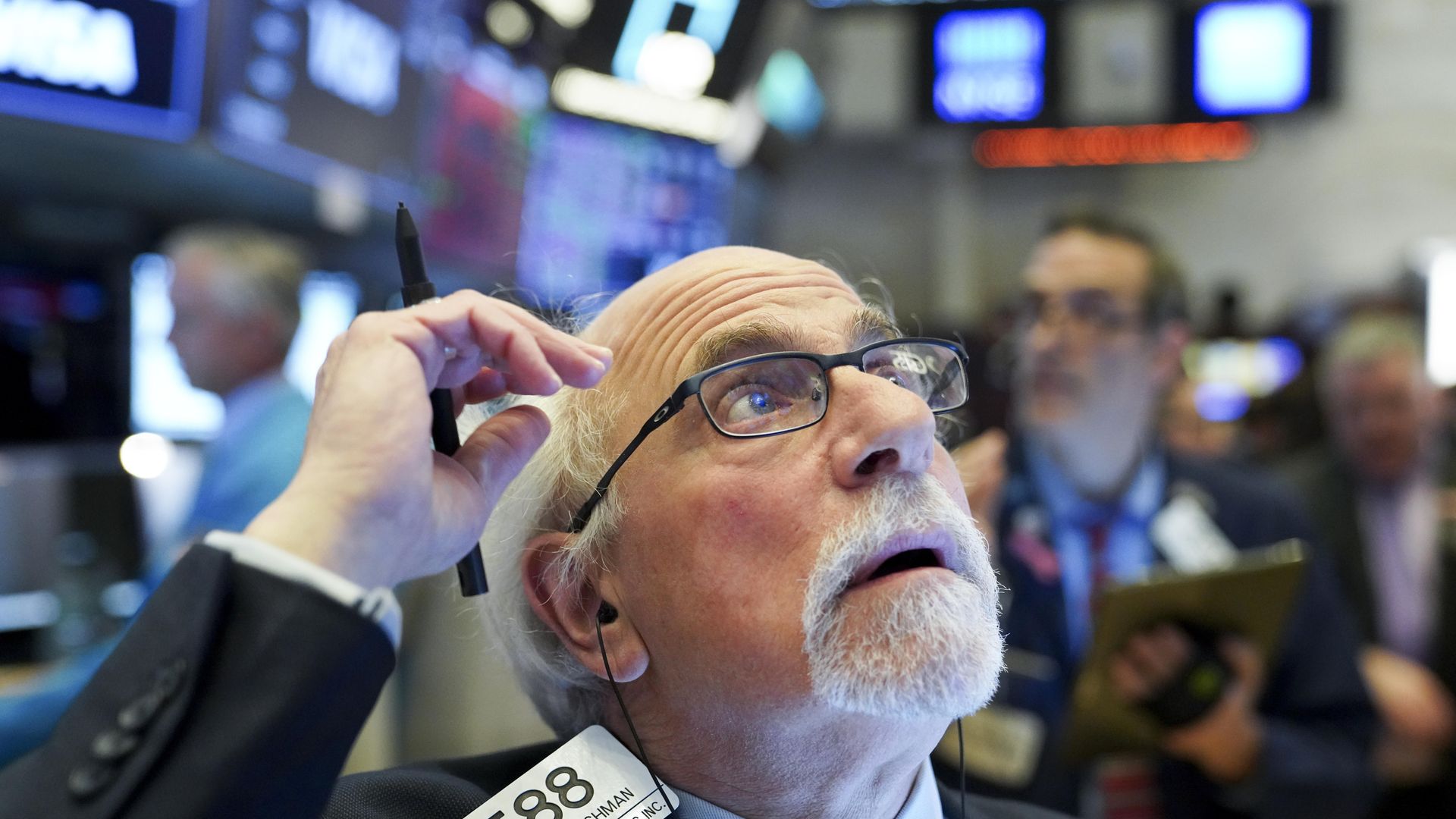 This is a classic photo of a stock market trader looking at a screen