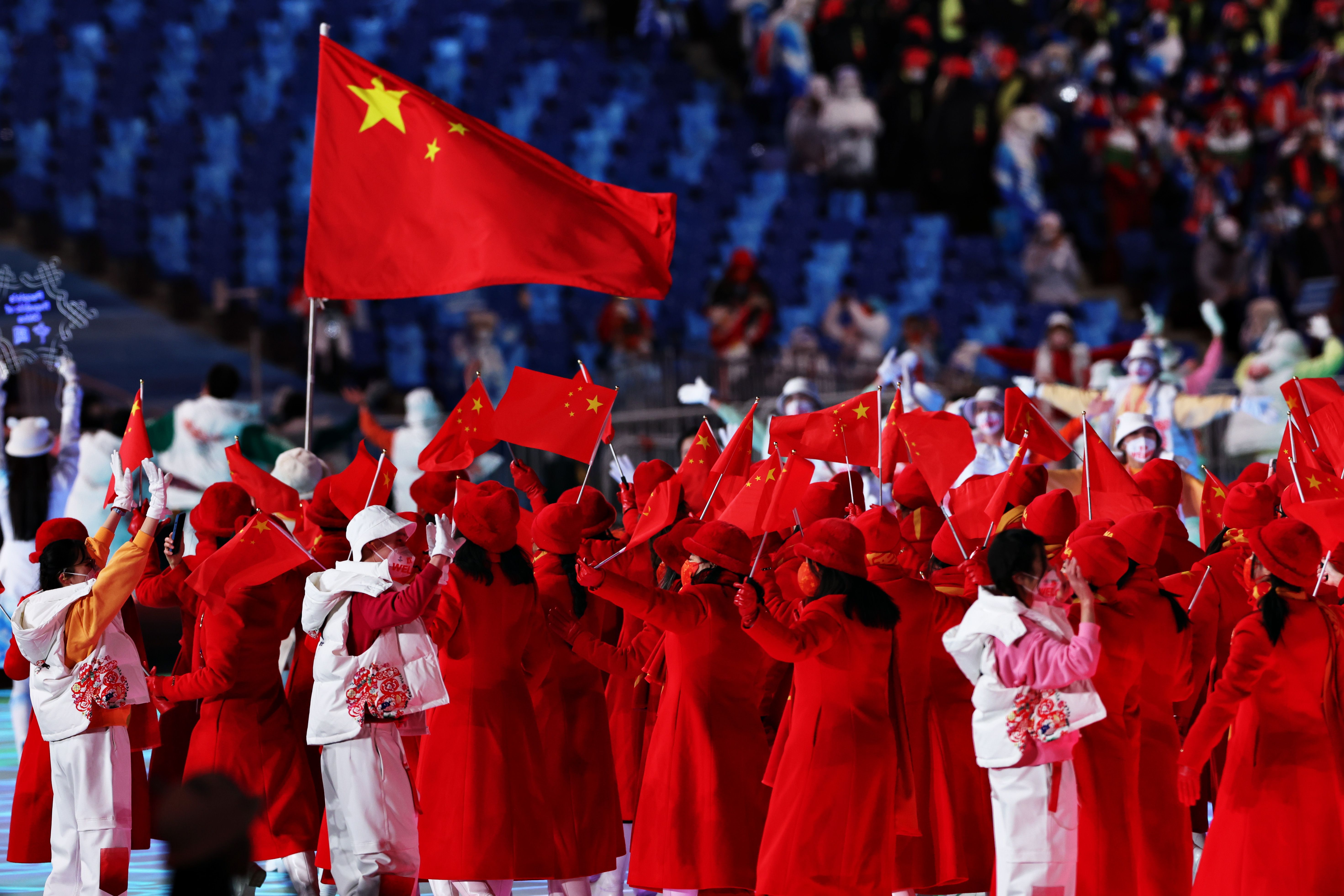 Members of Team China wave flags during the Opening Ceremony of the Beijing 2022 Winter Olympics 