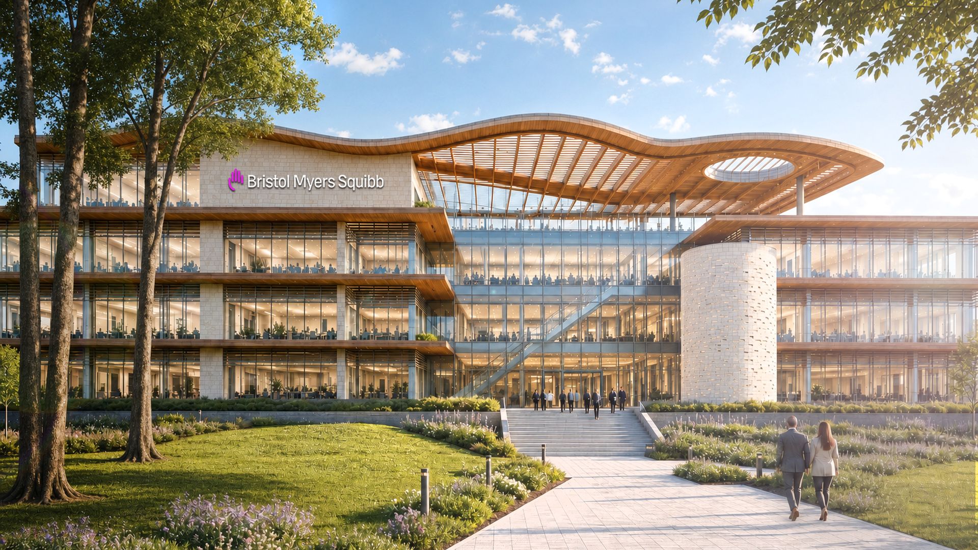 Modern Bristol Myers Squibb campus: a glass, multi-story building with a curved wooden roof and open terraces. A couple walks a paved path toward the entrance, framed by trees and landscaping.