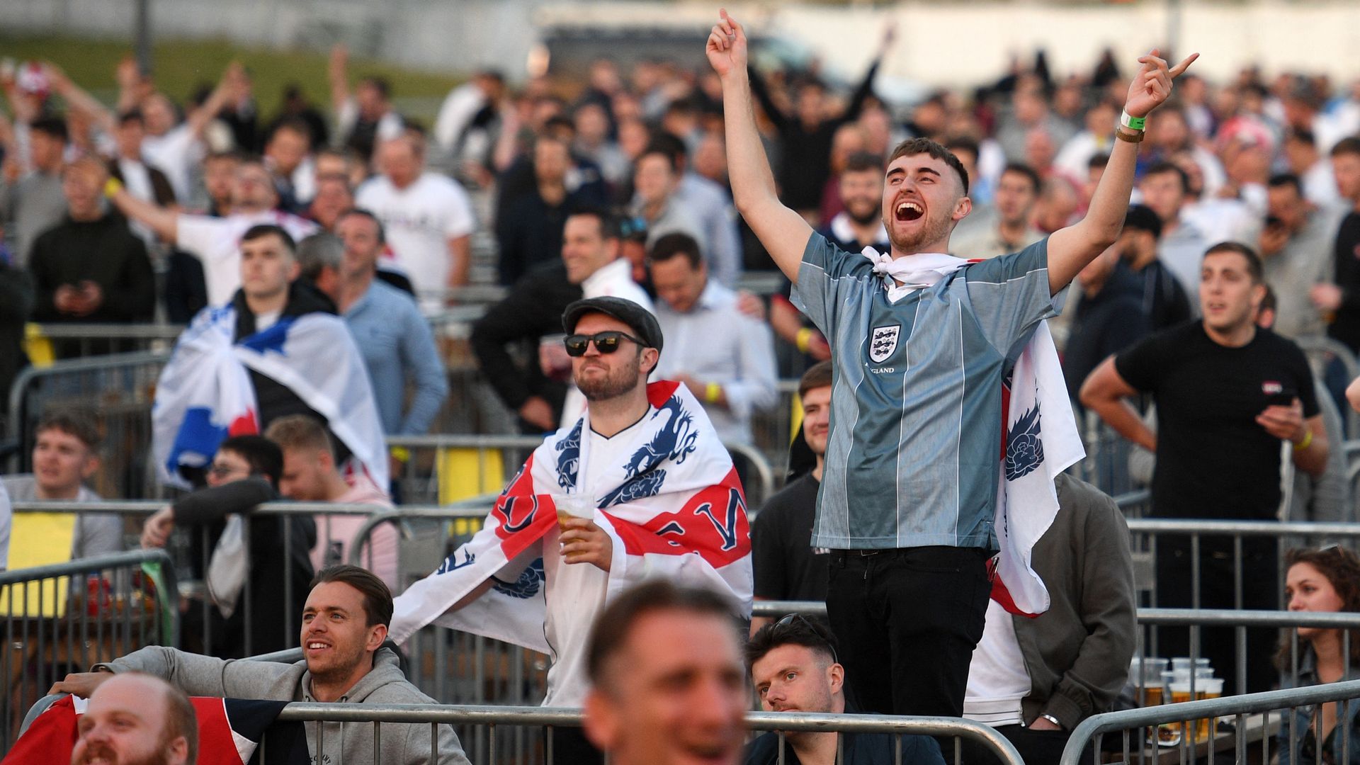 England supporters react to the news that Scotland have conceded a second goal to Croatia.