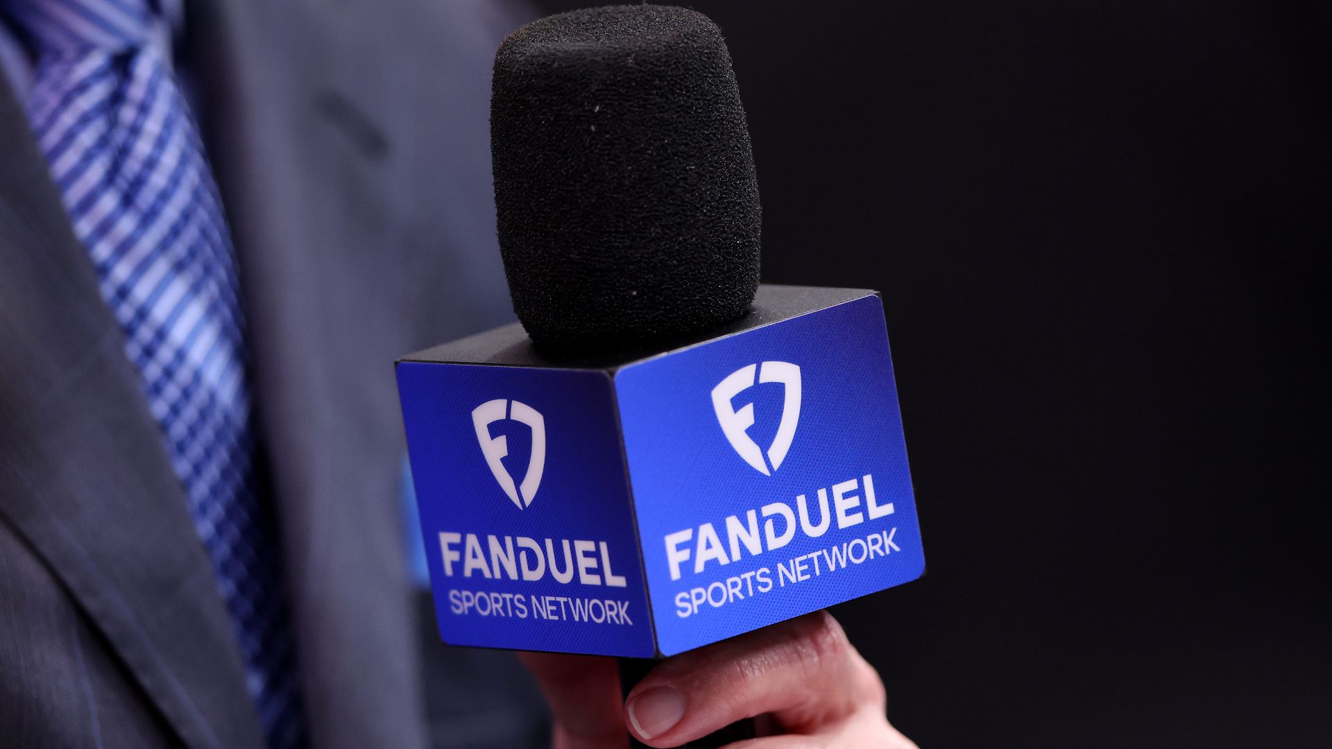 A detail of a microphone with FanDuel Sports Network branding 