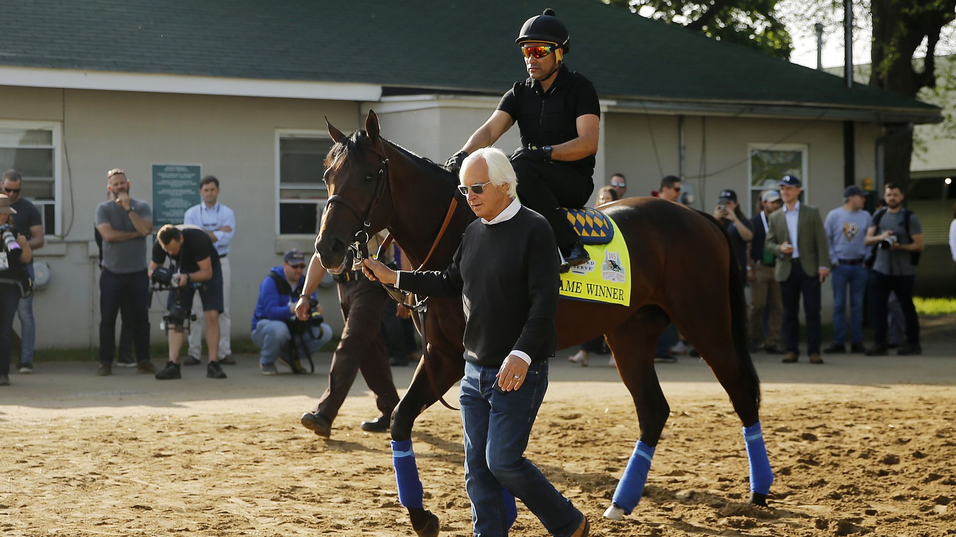 Trainer Bob Baffert leads Game Winner to the track