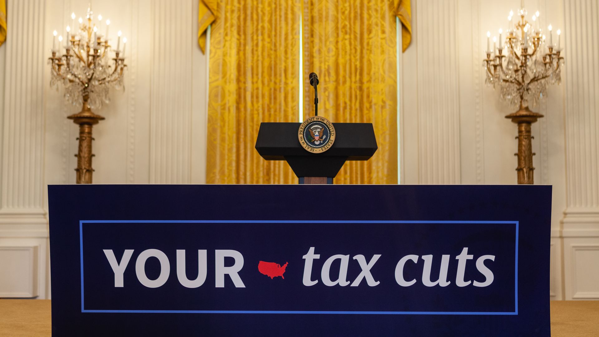 Sign that says "your tax cuts" referring to Trump's tax cut plan that passed last year.