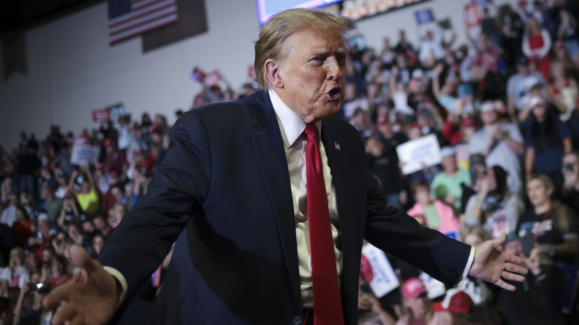 Republican presidential candidate and former President Donald Trump gestures to members of the audience as he leaves a Get Out The Vote rally at Coastal Carolina University 