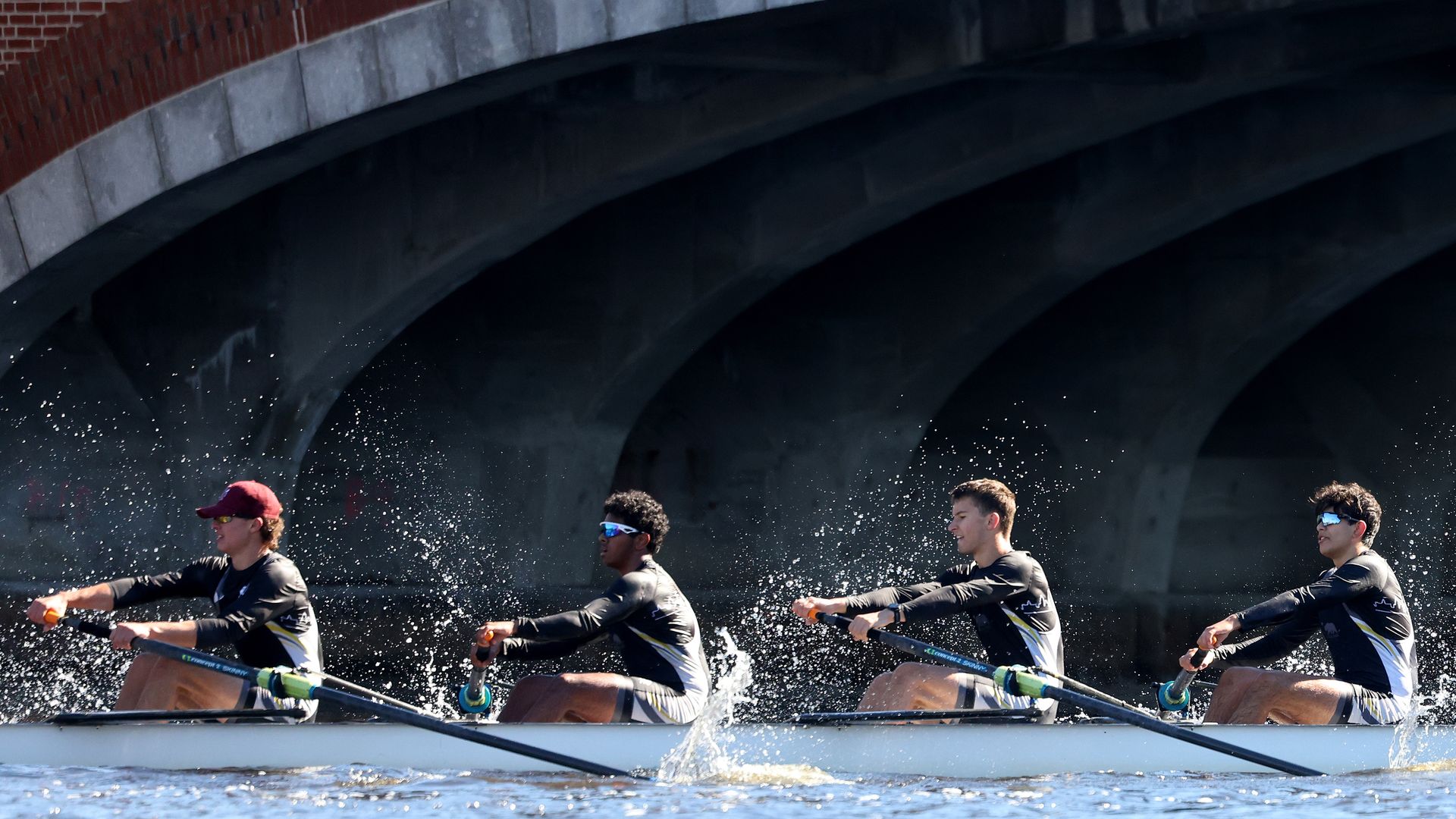 Rowers from Norcal Crew race in the men's youth eight event at the Head of the Charles Regatta in Cambridge.