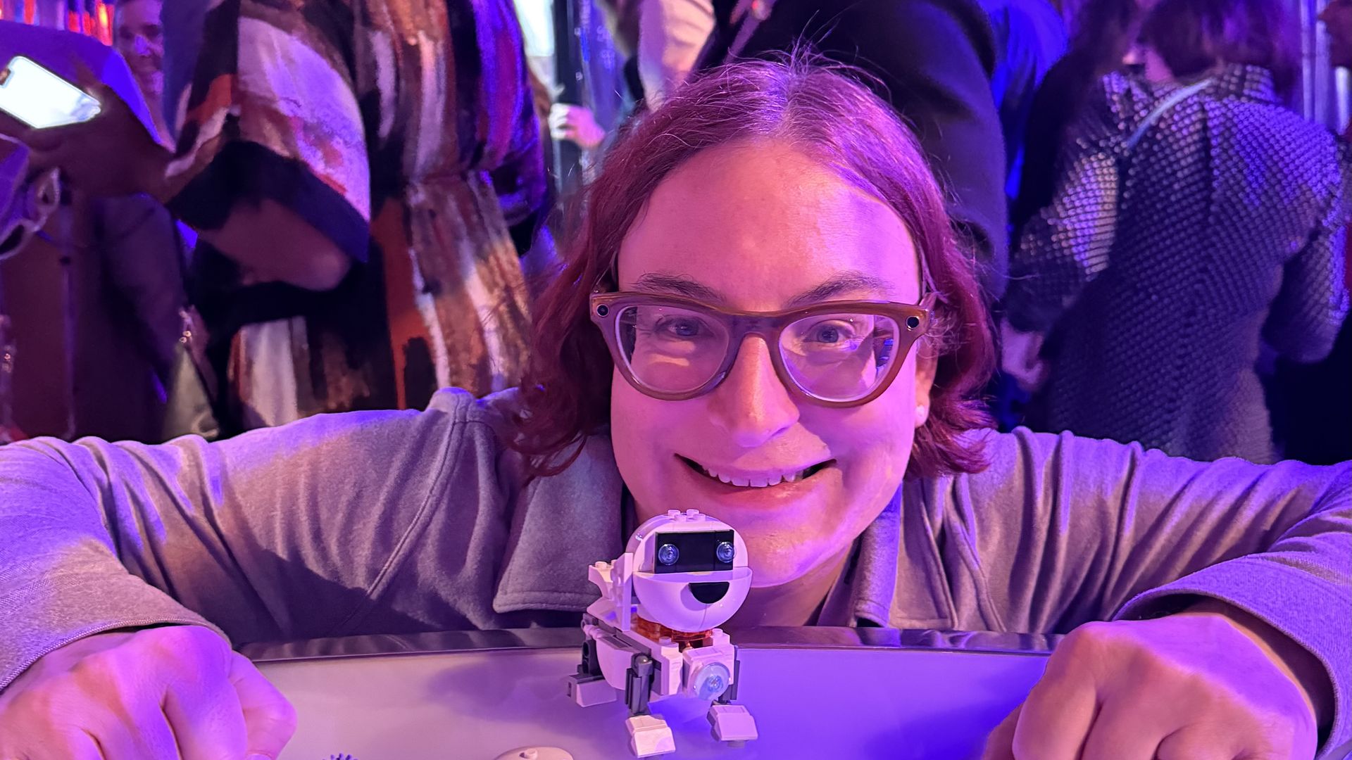 A very happy Ina Fried next to a robot Lego dog.