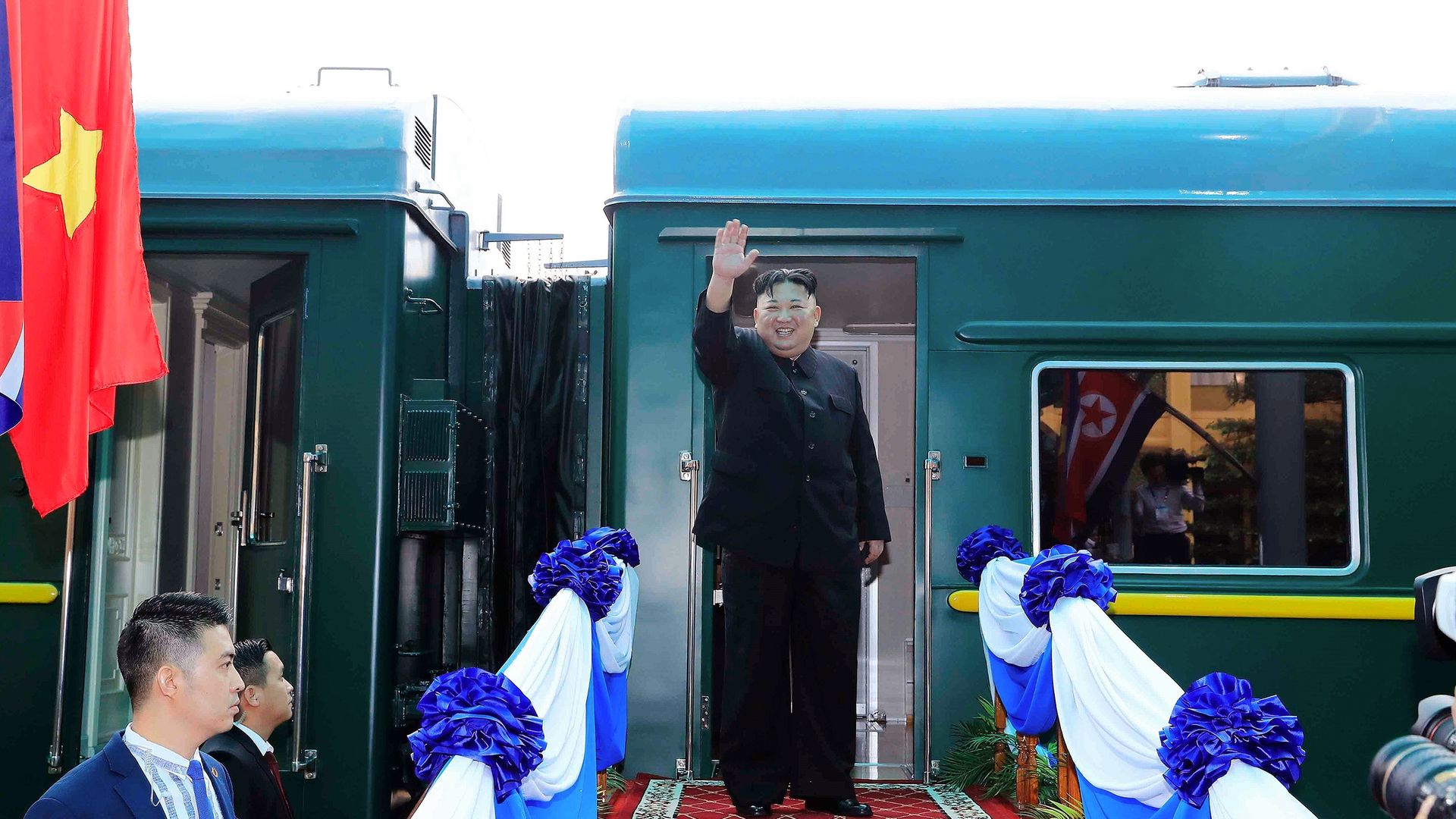 North Korea's leader Kim Jong Un waves before boarding his train 