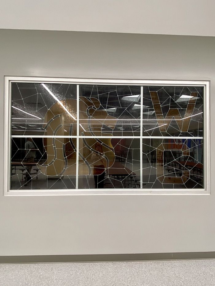 Stained glass from the old school. Photo: Ashley Mahoney/Axios 