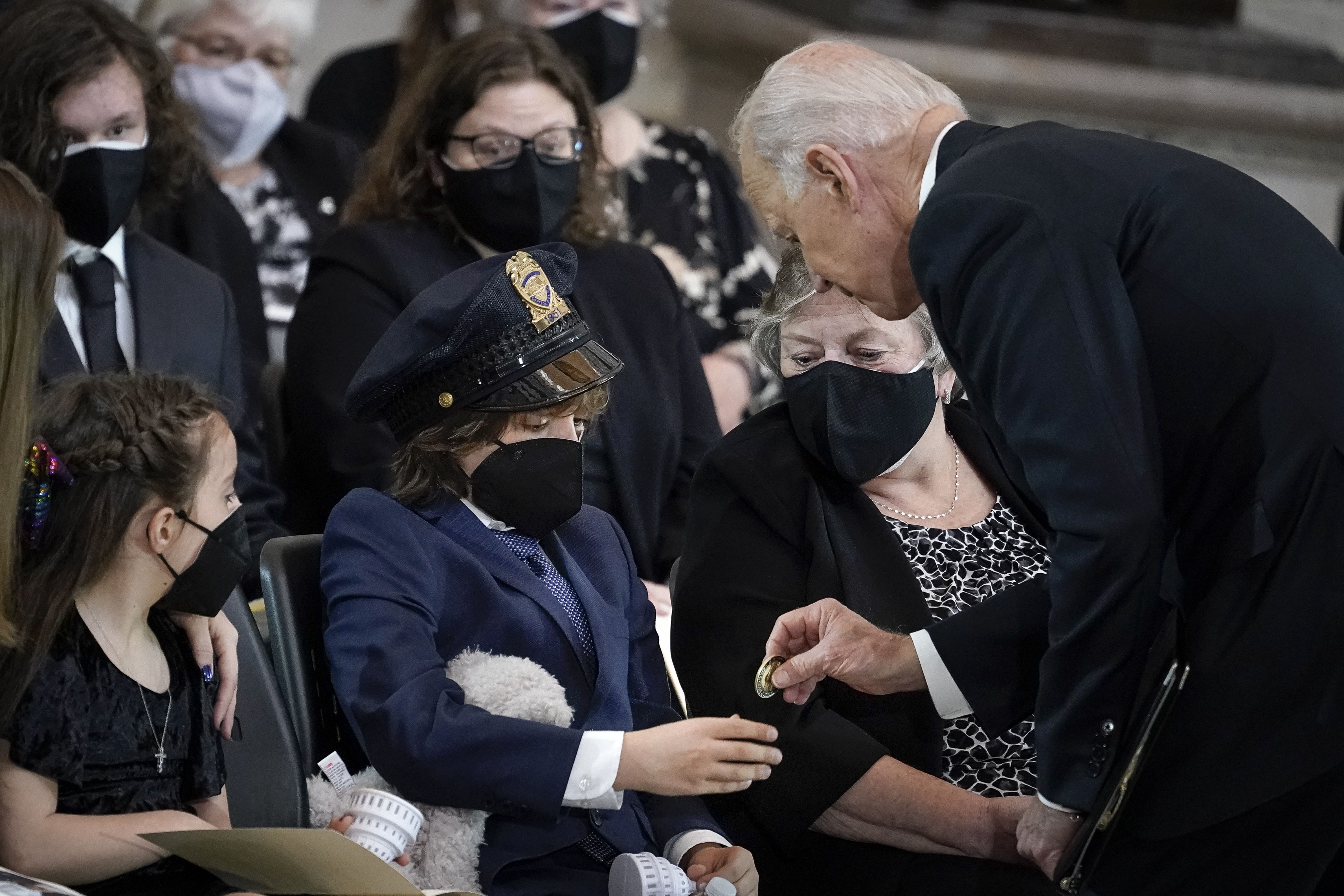 Biden giving a coin to child of fallen Capitol police officer