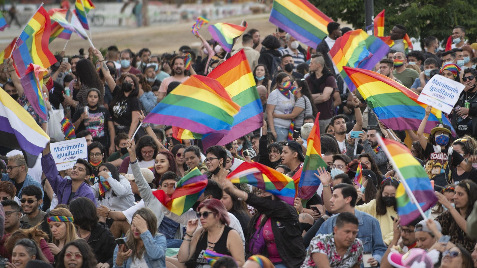  People celebrate waving rainbow flags during a rally after the bill for same-sex marriage was approved by the Chilean senate on December 7