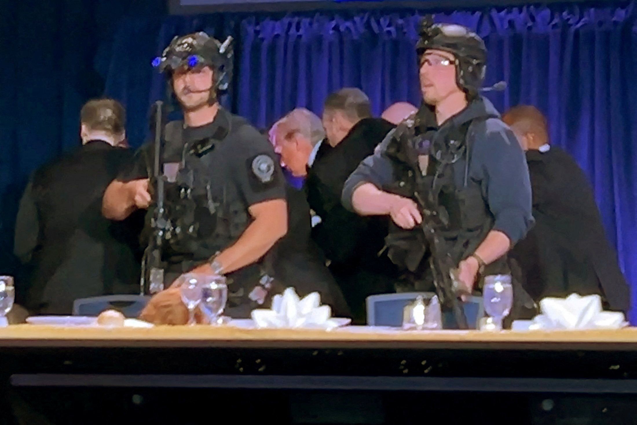 U.S. President Donald Trump is escorted out after a man opened fire with a shotgun on security personnel outside the room, during the annual White House Correspondents' Association dinner in Washington, D.C., U.S., April 25, 2026, in this still image from video. REUTERS/Bo Erickson 