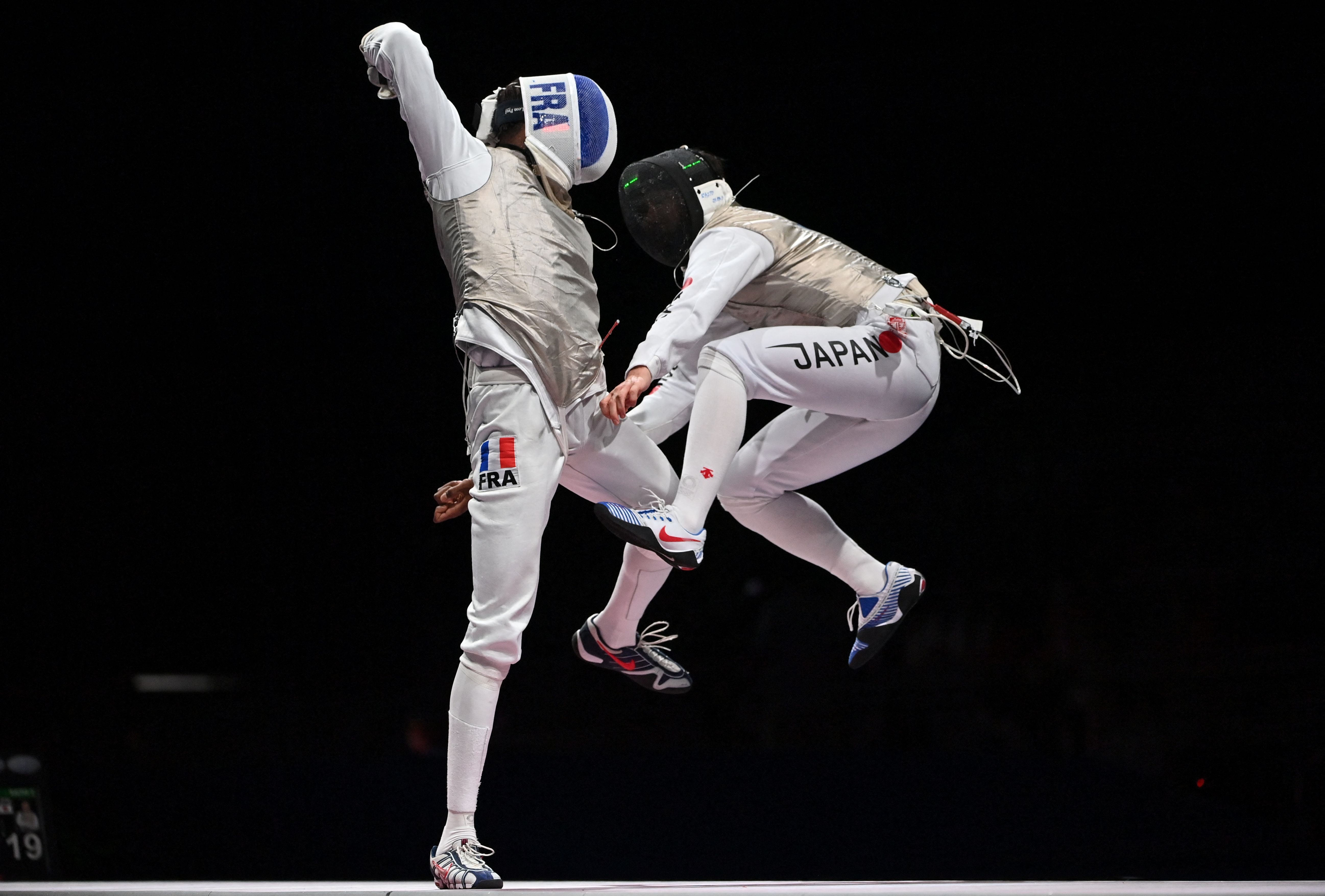 France's Enzo Lefort compete (L) against Japan's Toshiya Saito in the mens team foil semi-final bout during the Tokyo 2020 Olympic Games on August 1