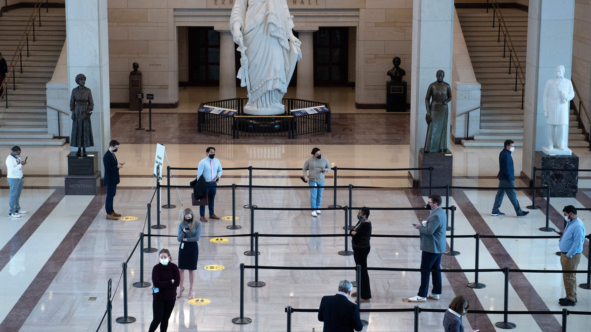 Congressional workers and others line up in the Capitol Visitor Center to await COVID-19 tests.