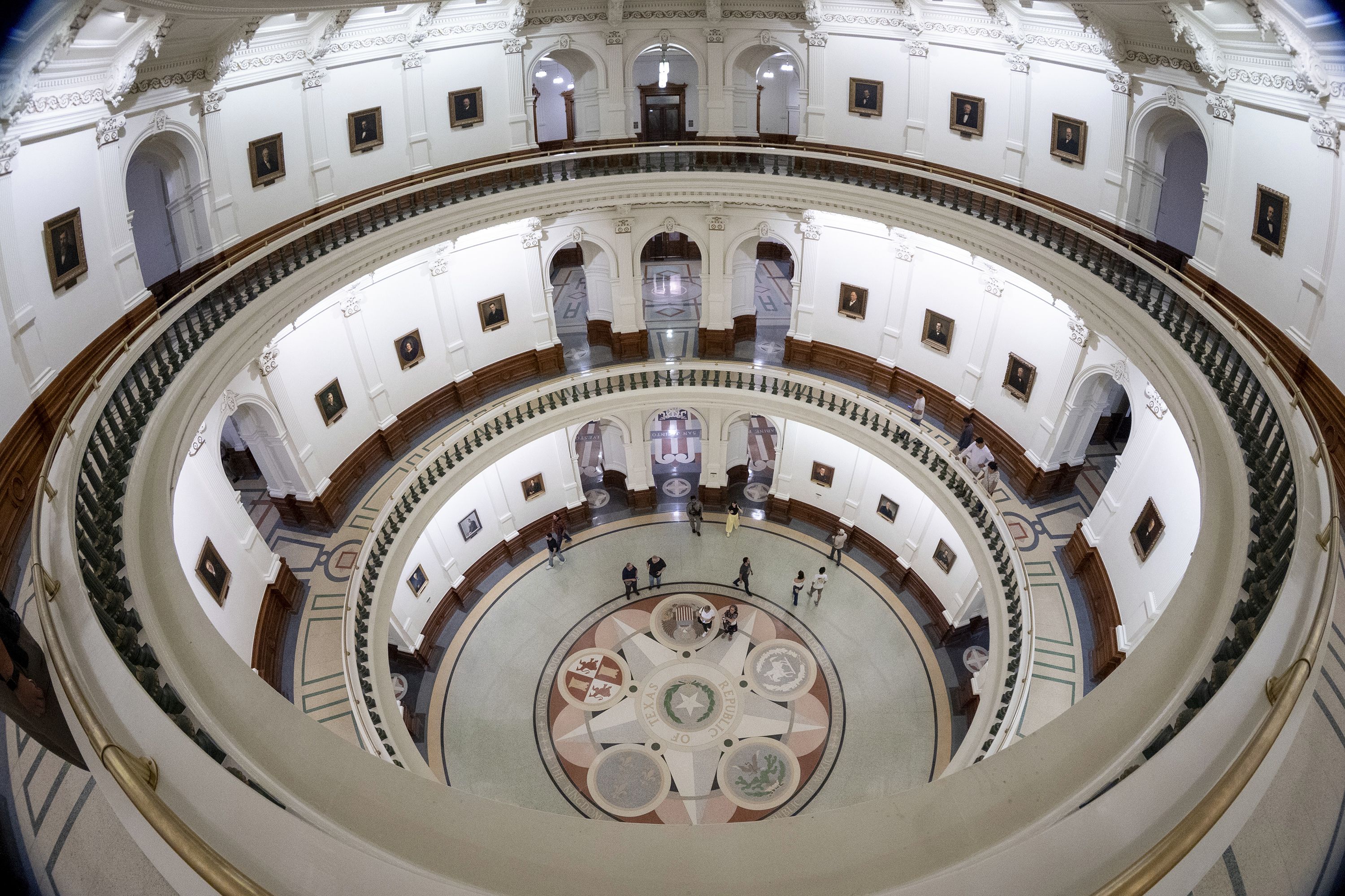 Visitors explore the rotunda into the late night as the Senate takes a recess before hearing more debate over a bill on a redrawn U.S. congressional map during a special session at the Texas Capitol in Austin, Texas, Friday, Aug. 22, 2025. (AP Photo/Stephen Spillman)
