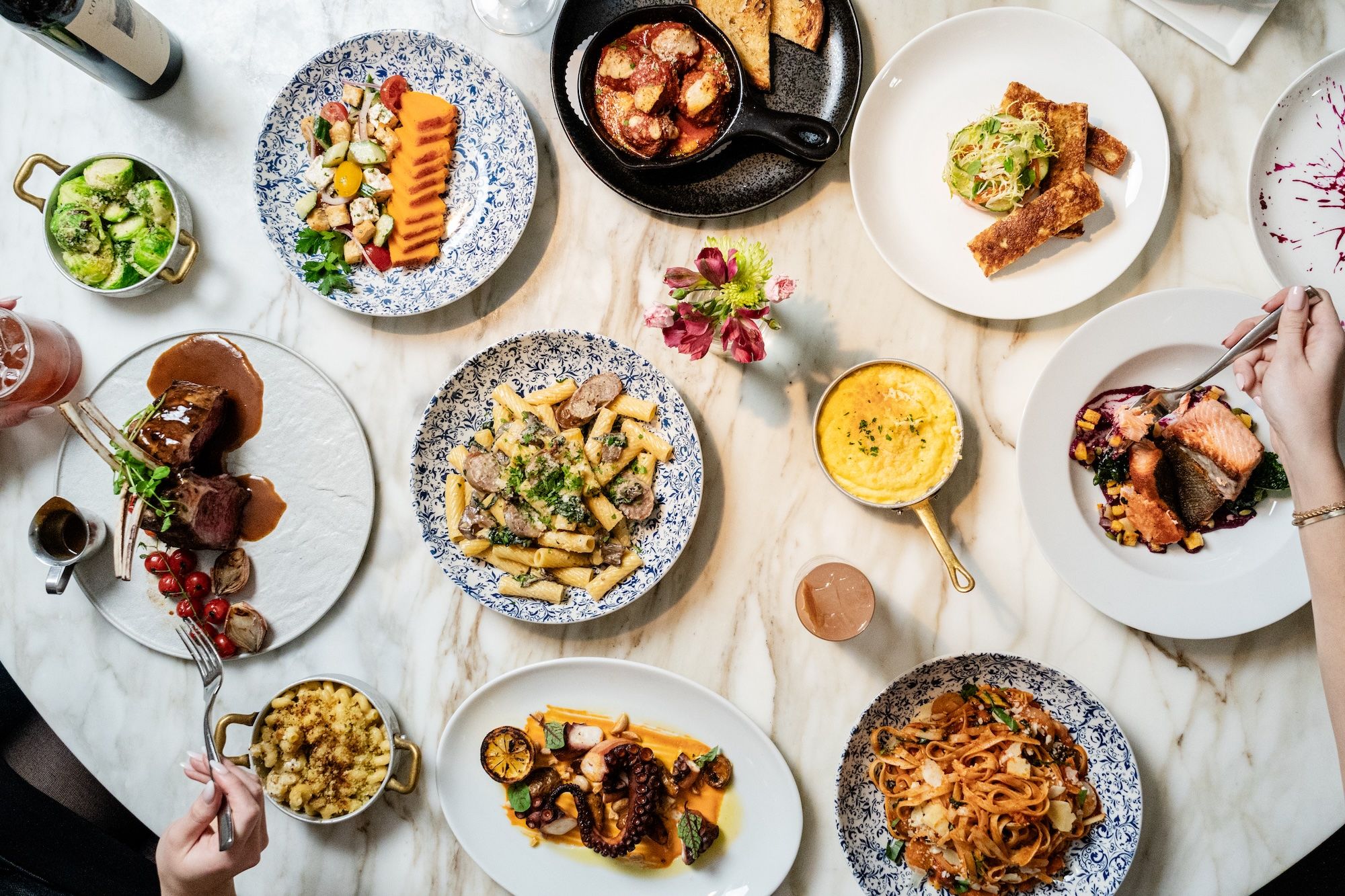 A table with various plates of food.