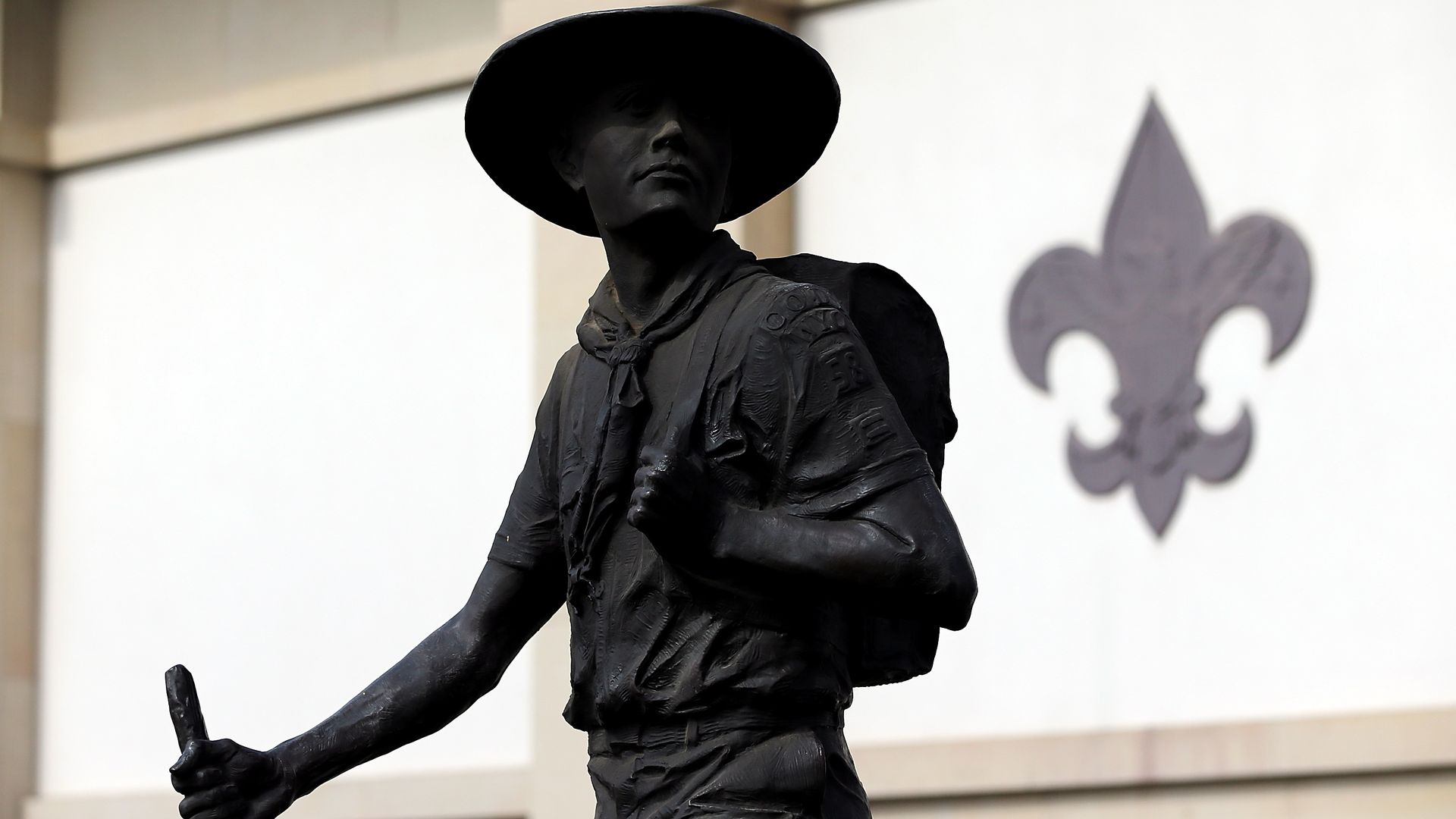 A statue of a boy scout looking over his shoulder