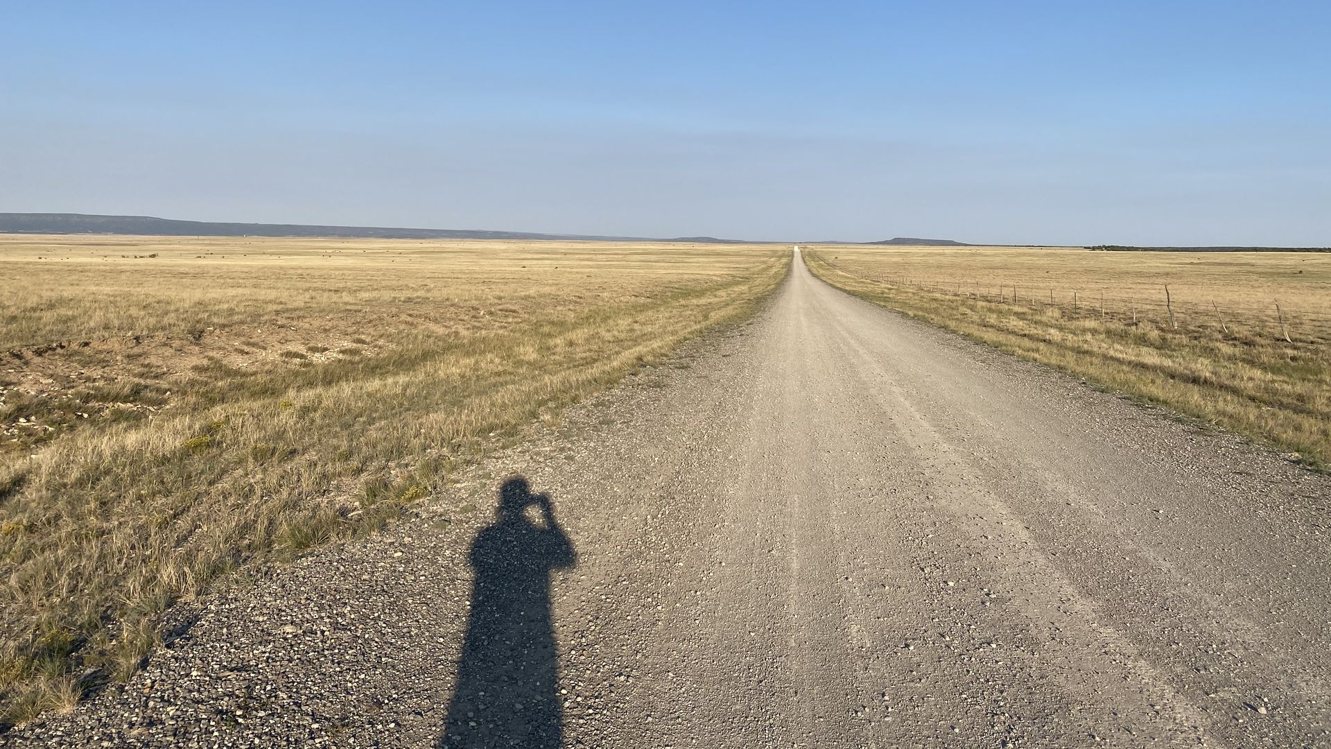 A photo of a long gravel road. 
