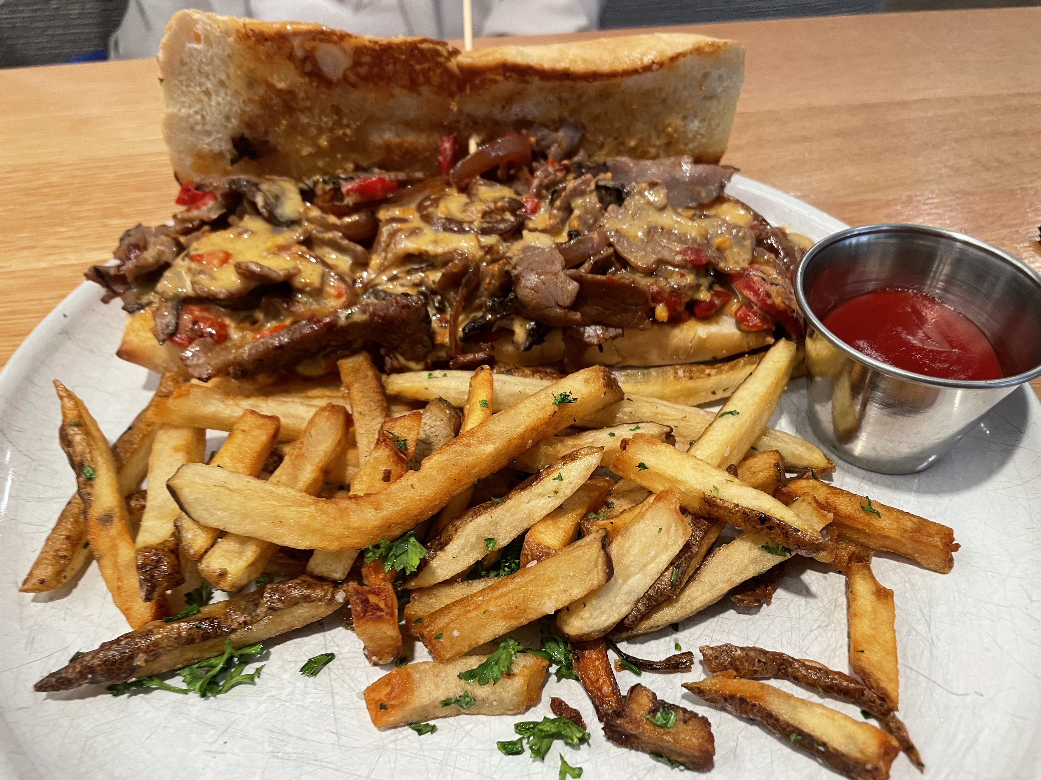 Cheesesteak and fries on a plate