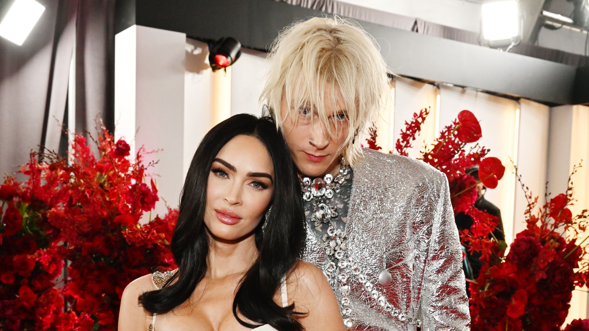 Megan Fox and Machine Gun Kelly pose for a picture on a red carpet. 
