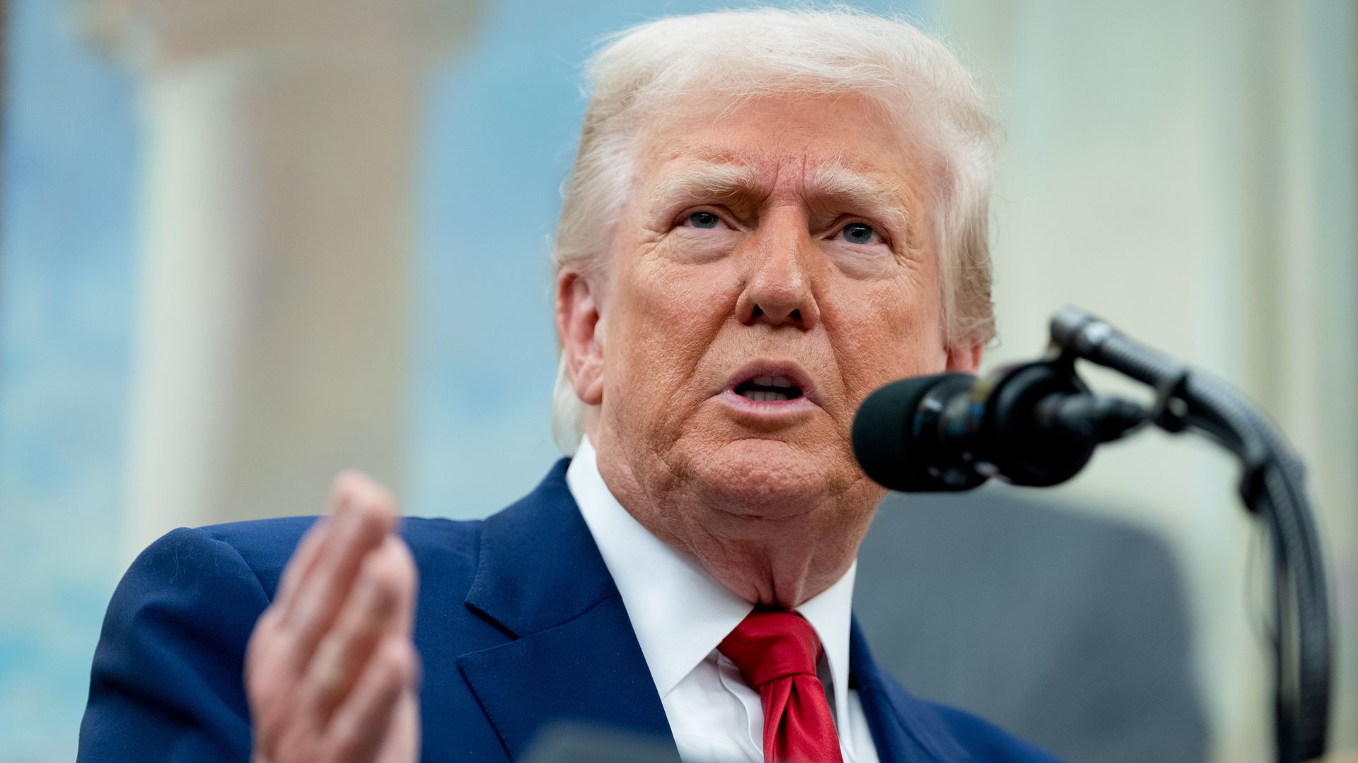 Trump speaks at a microphone