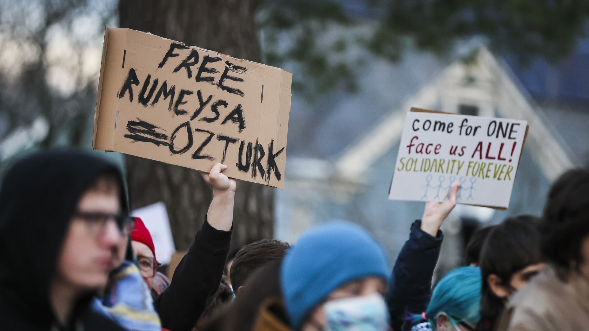 Signs at a protest to free Tufts international student Rumeysa Ozturk, with a sign saying "free Rumeysa Ozturk"