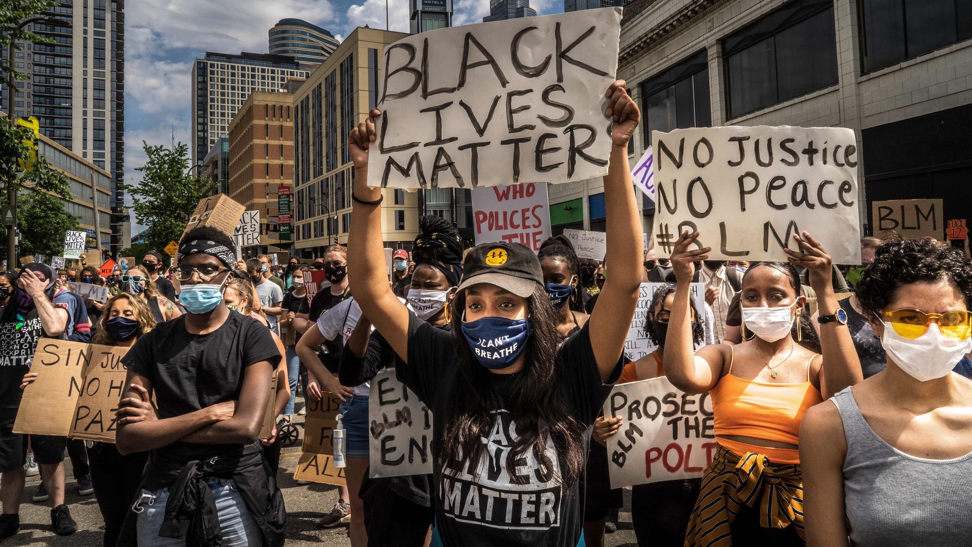 Protesters hold signs outside the Minneapolis 1st Police precinct during a demonstration against police brutality and racism on June 13, 2020 in Minneapolis, Minnesota