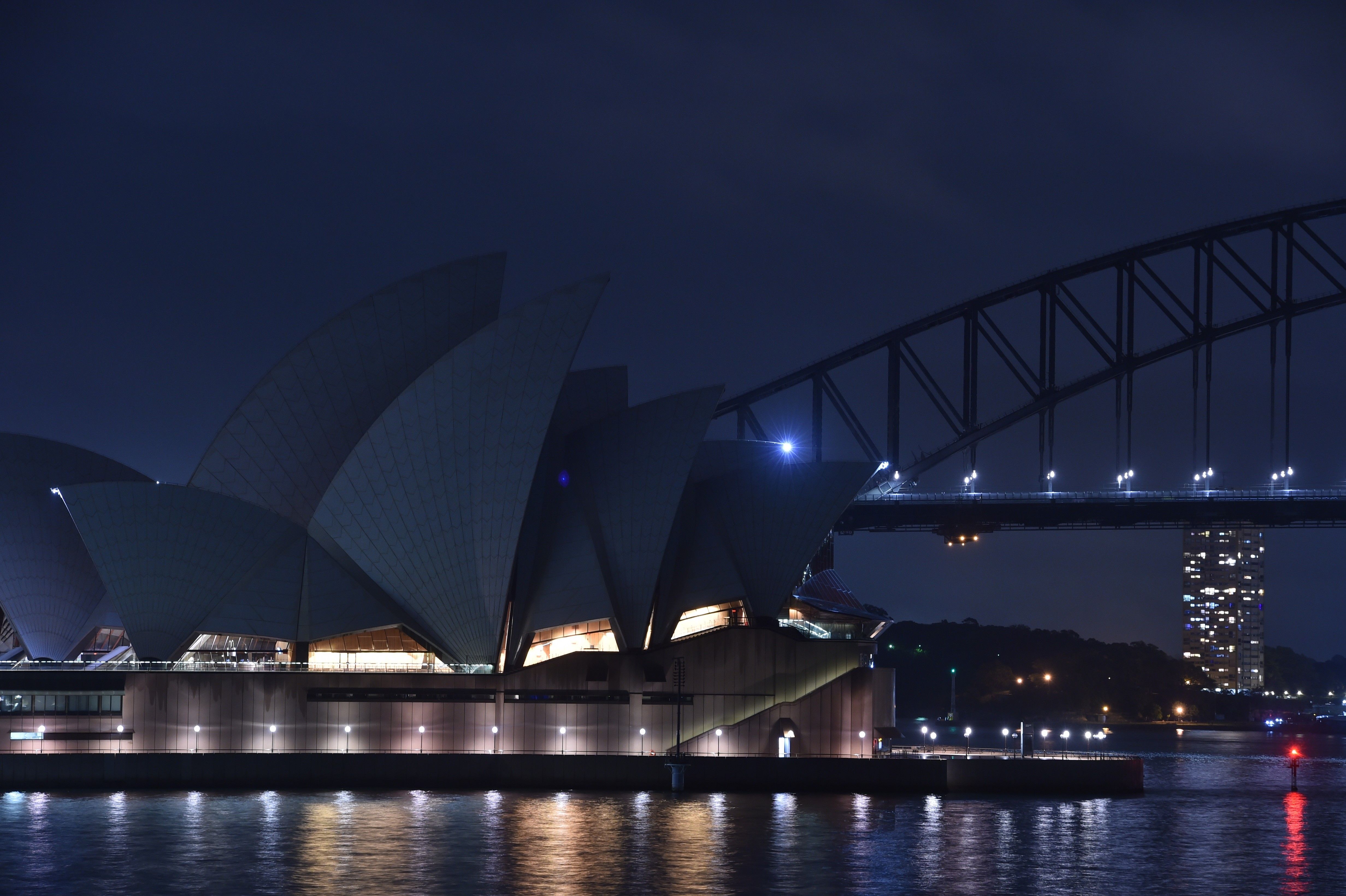 Sydney Harbour Bridge and the Opera House are plunged into darkness for the Earth Hour event