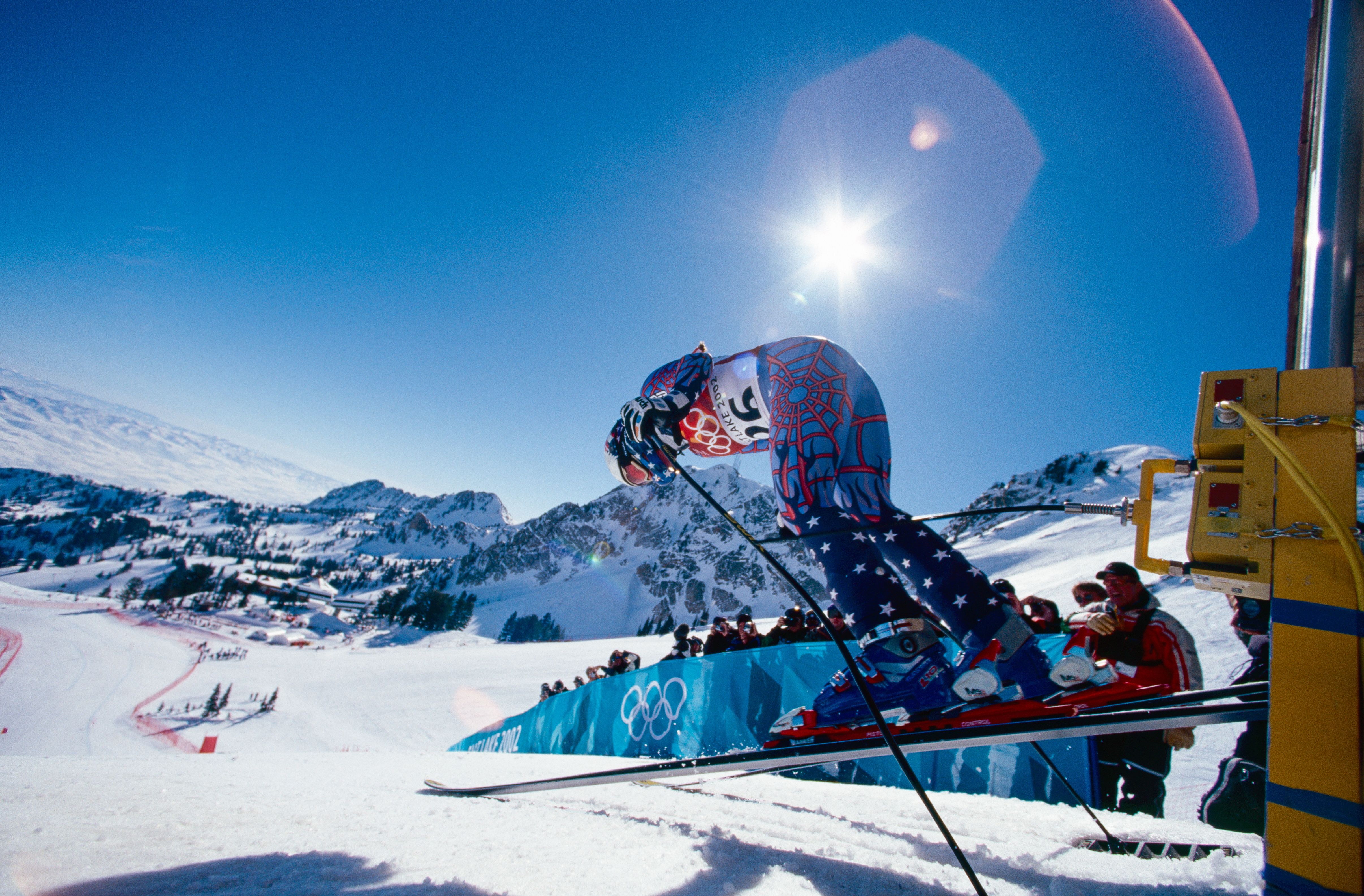 A skiier jumps in the air.