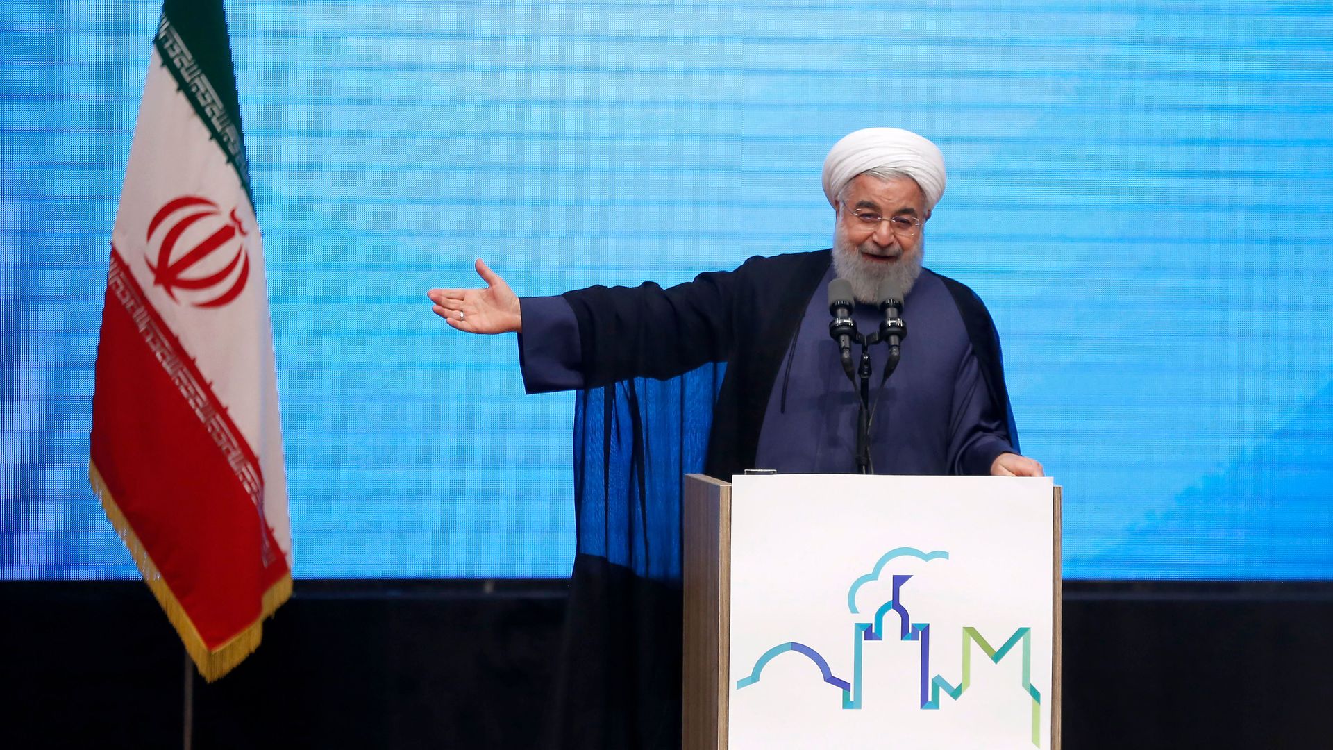 Rouhani pointing to Iran flag