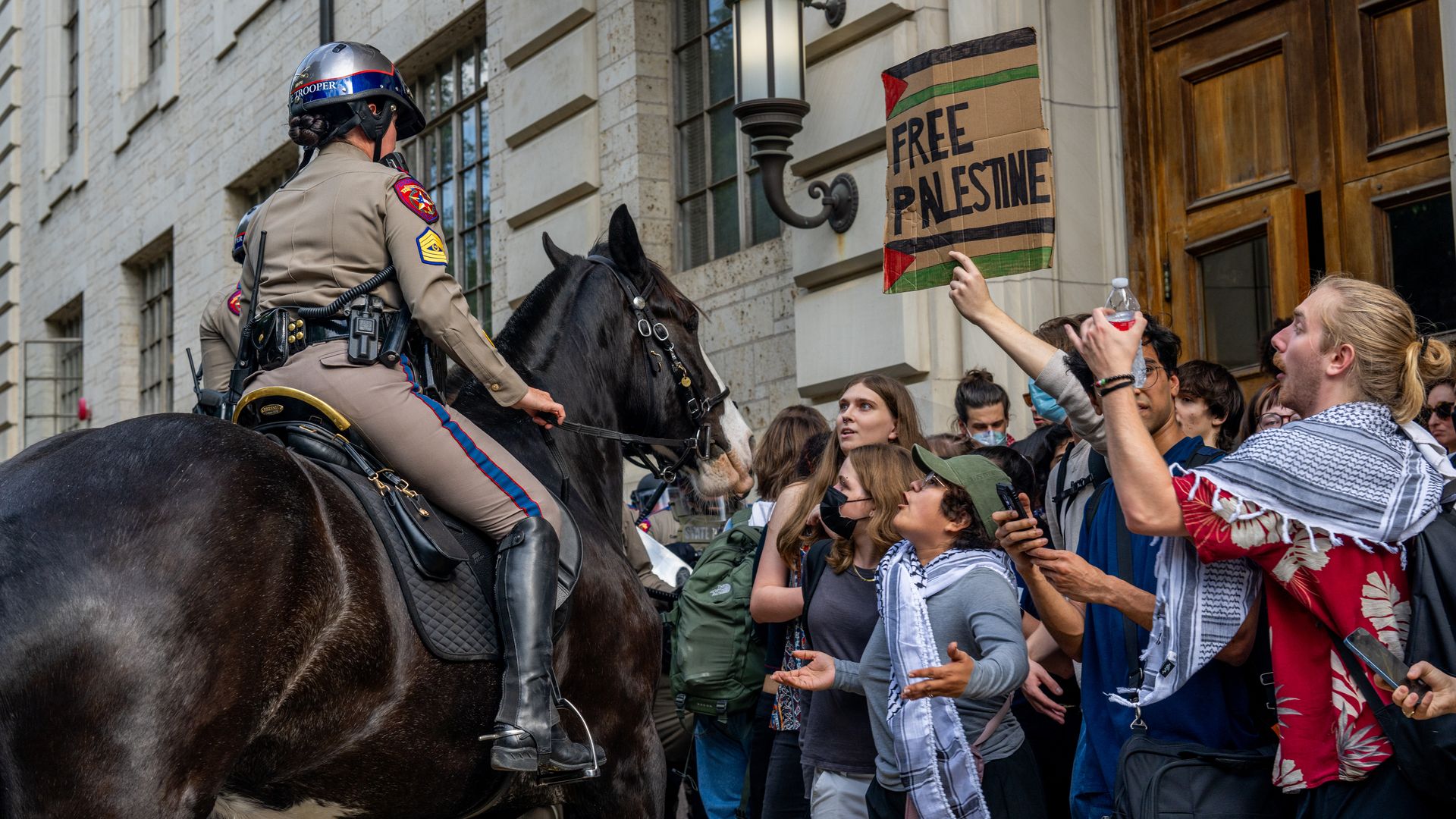 A Mounted police officer near Pro-Palestinian protesters on a Texas college campus.