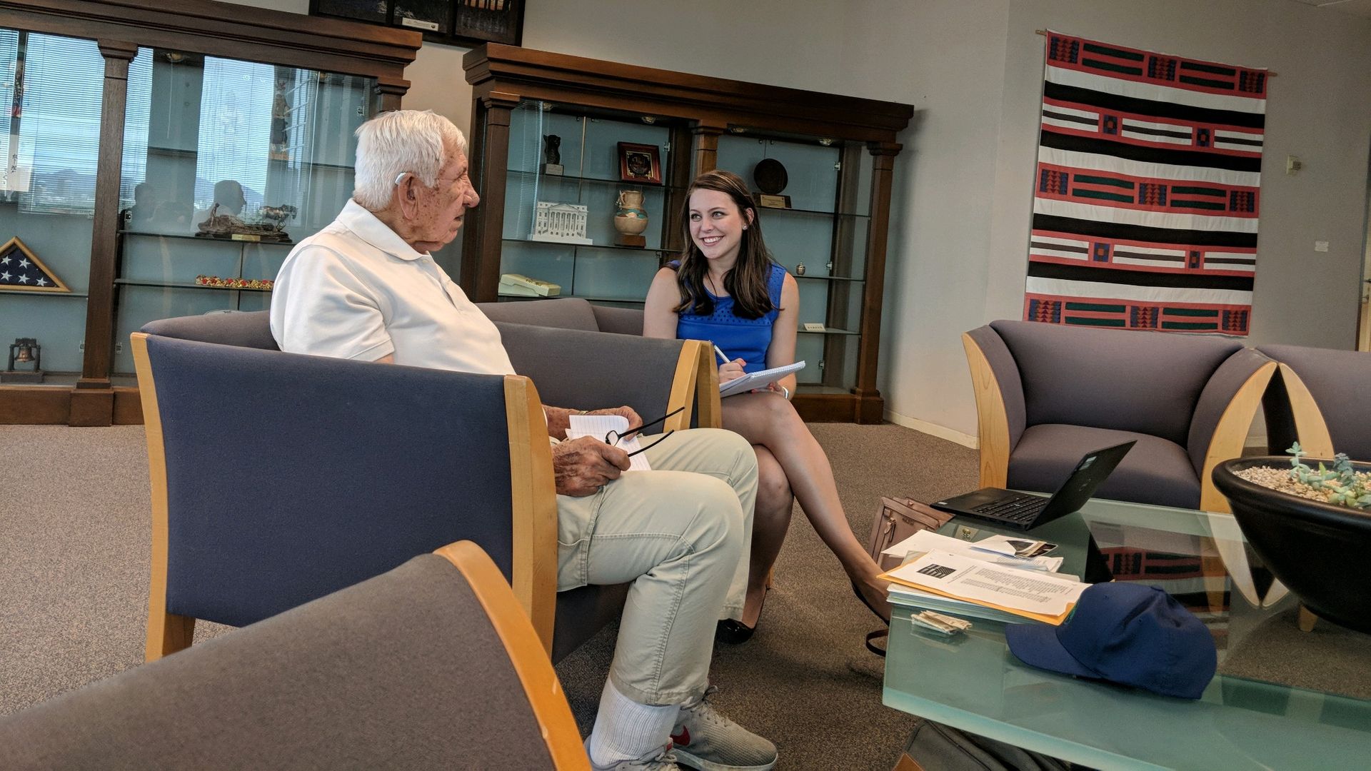 A woman talking to an older man. 