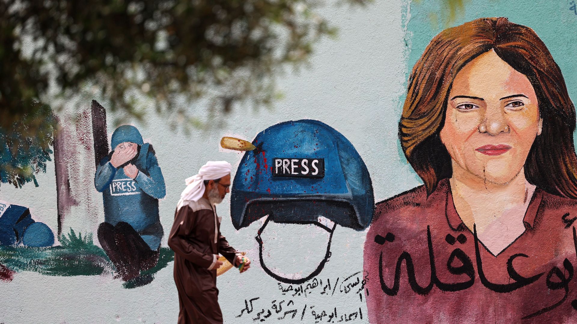 Palestinian man walks past a mural painted by an artist in honour of slain veteran Al-Jazeera journalist Shireen Abu Akleh, in Gaza City on May 13, 2022.