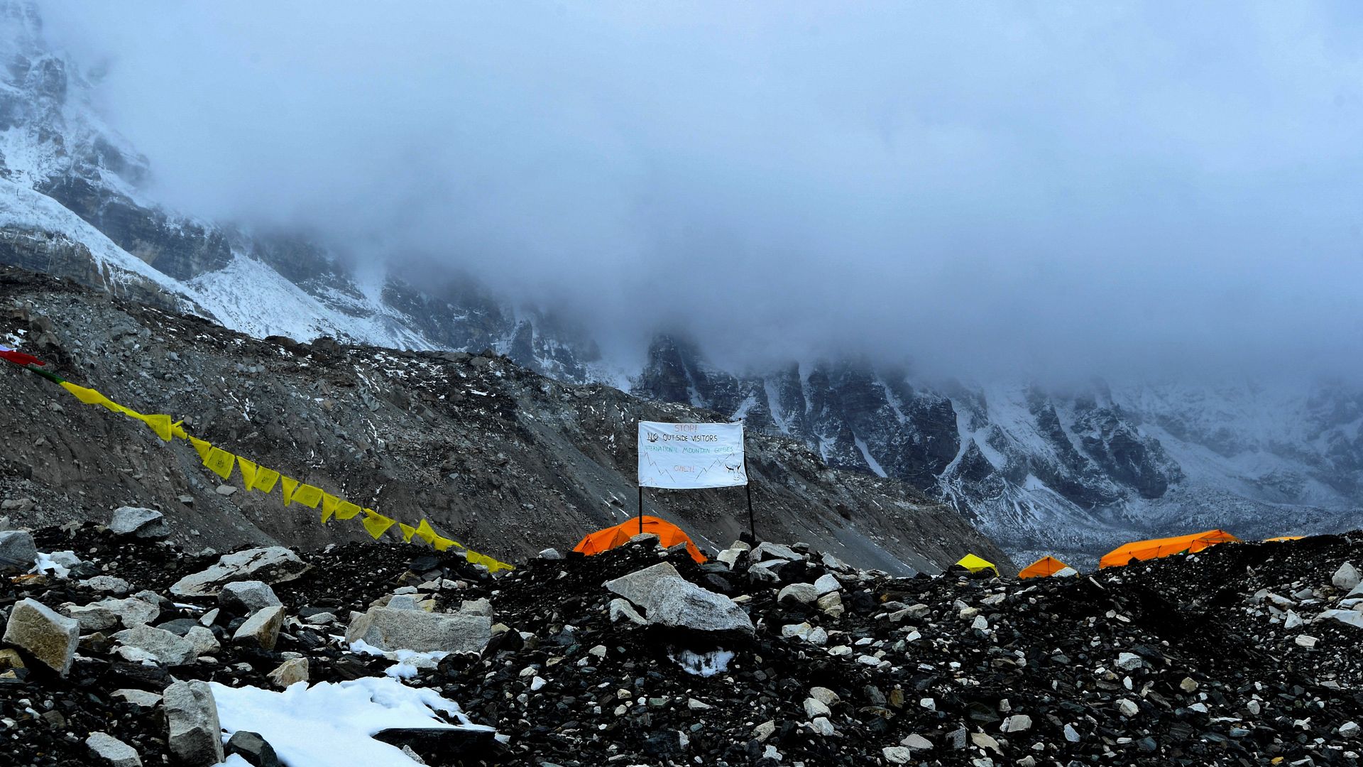 Picture of a sign in Everest that says "Stop ! No outside visitors. Intenrational Mountain Guides only !"