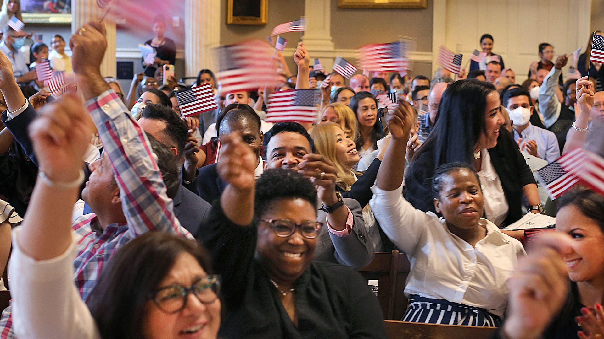 Naturalized citizens waving American flag