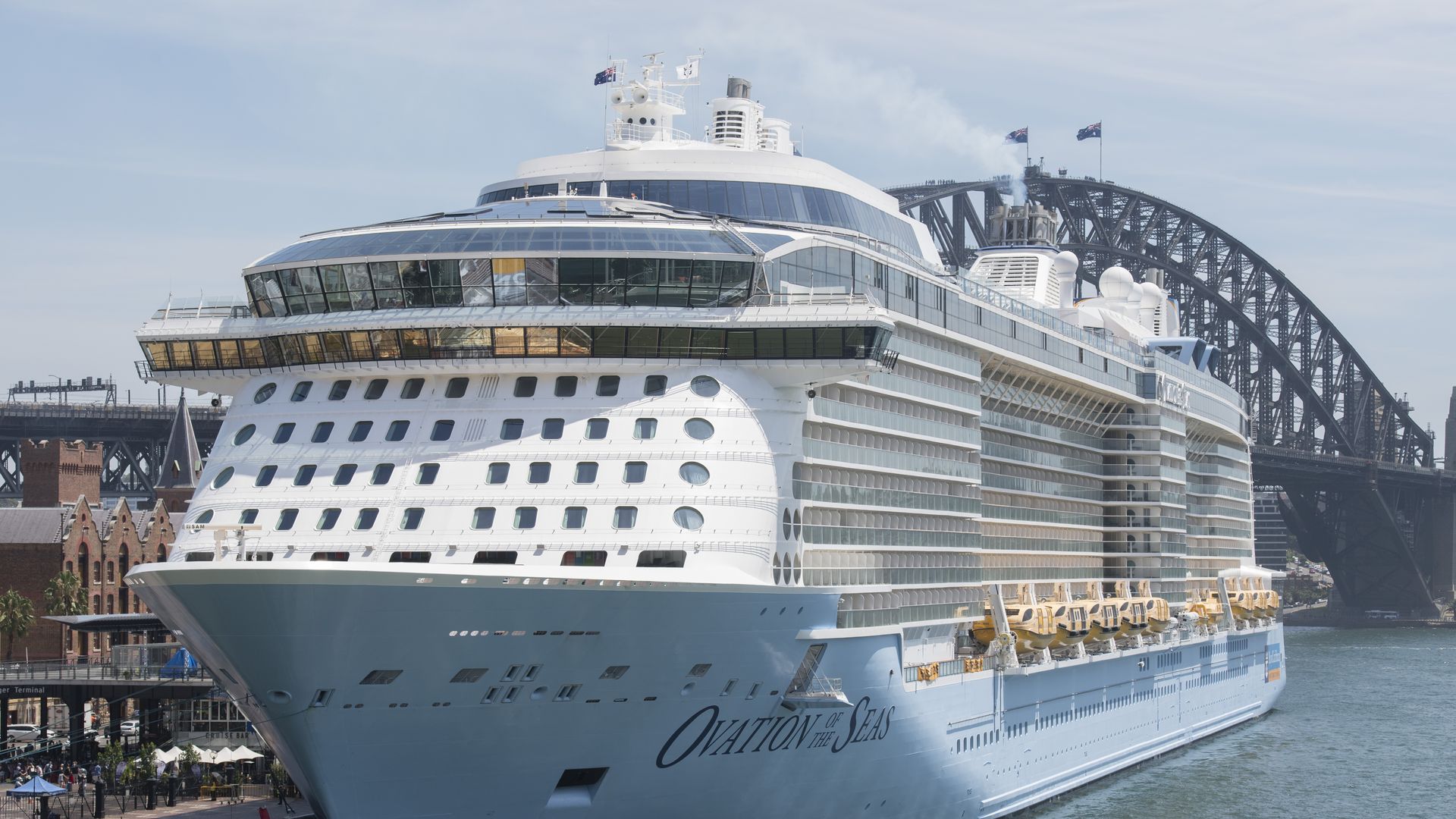 A cruise ship in the water at the dock.