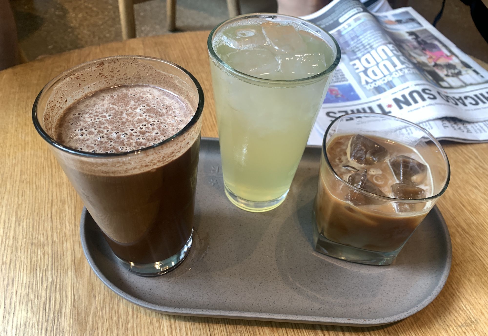 Tall glass of coffee, tall glass of iced tea and short glass of coffee with ice cubes.